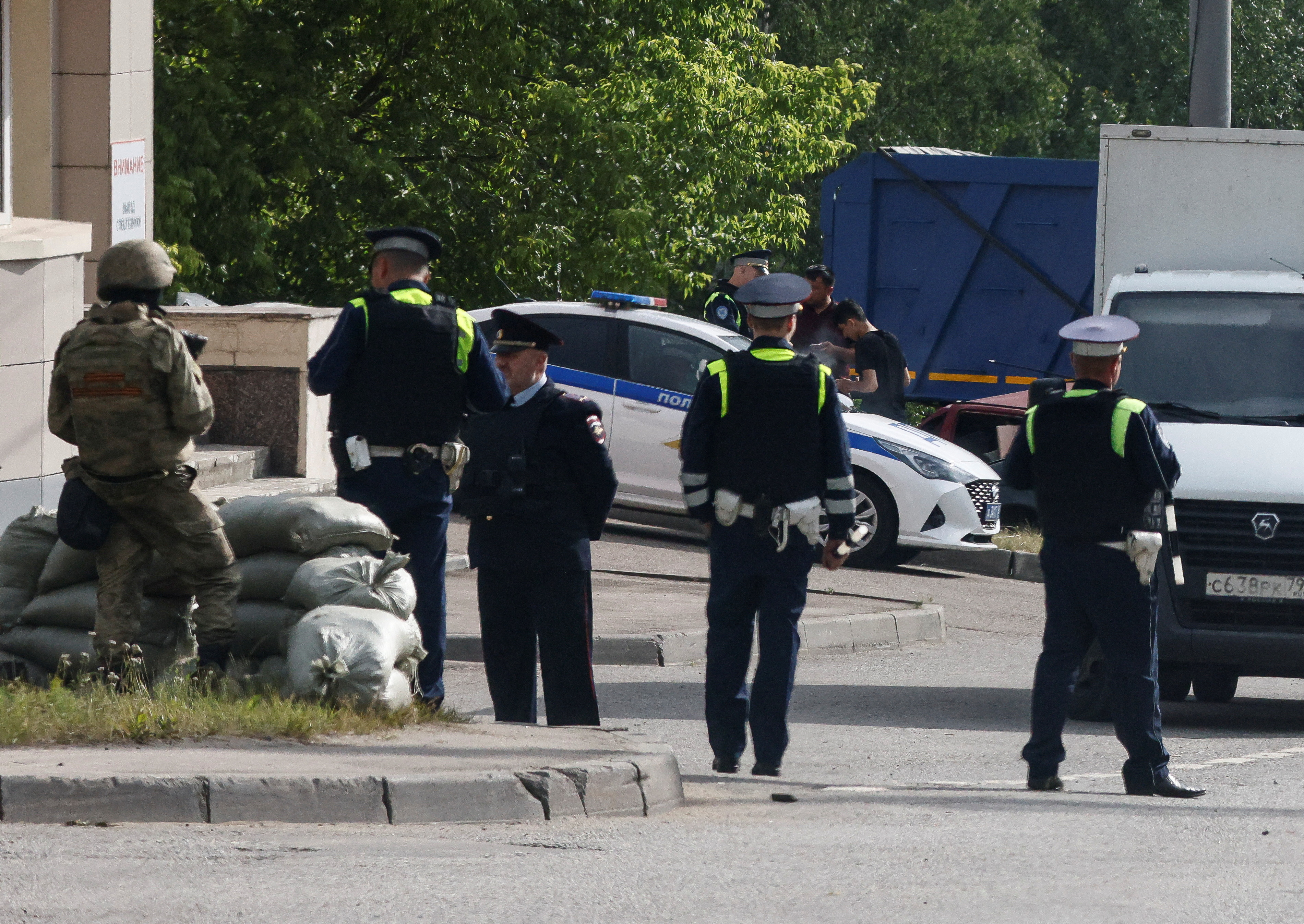 Security personnel watch traffic at a checkpoint in Moscow