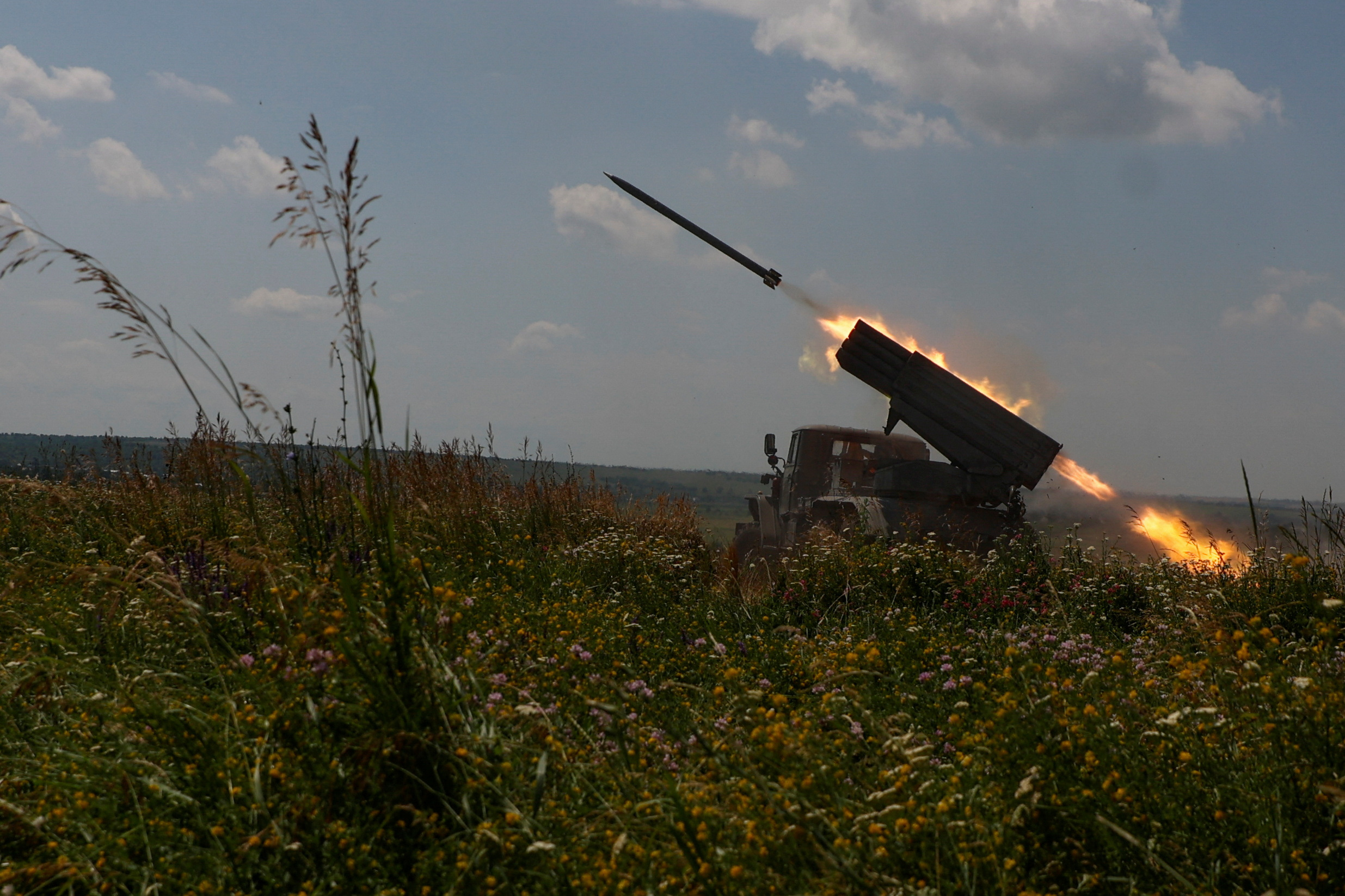 Ukrainian servicemen fire a BM-21 Grad multiple launch rocket system towards Russian troops near a front line in Zaporizhzhia region