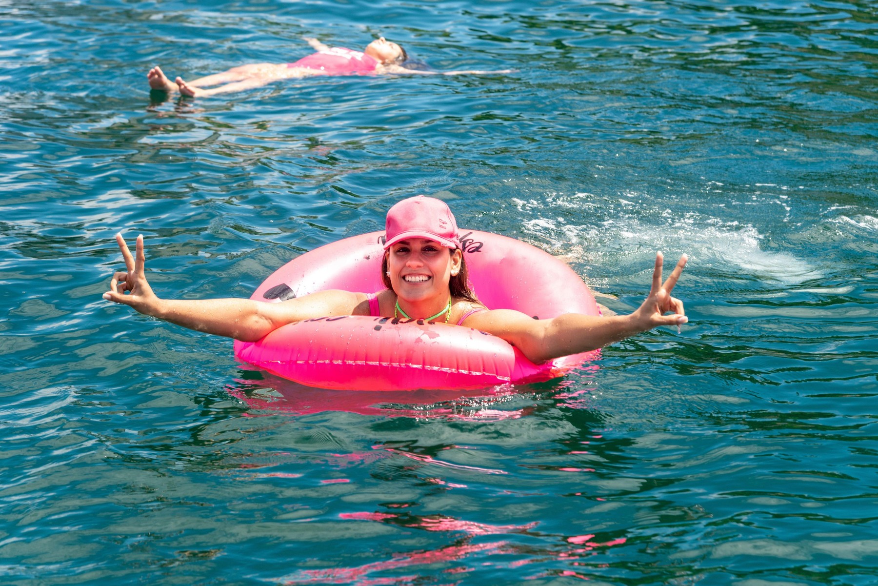 Woman in a bikini in the sea water with a buoy. Salvador Bahia Brazil.