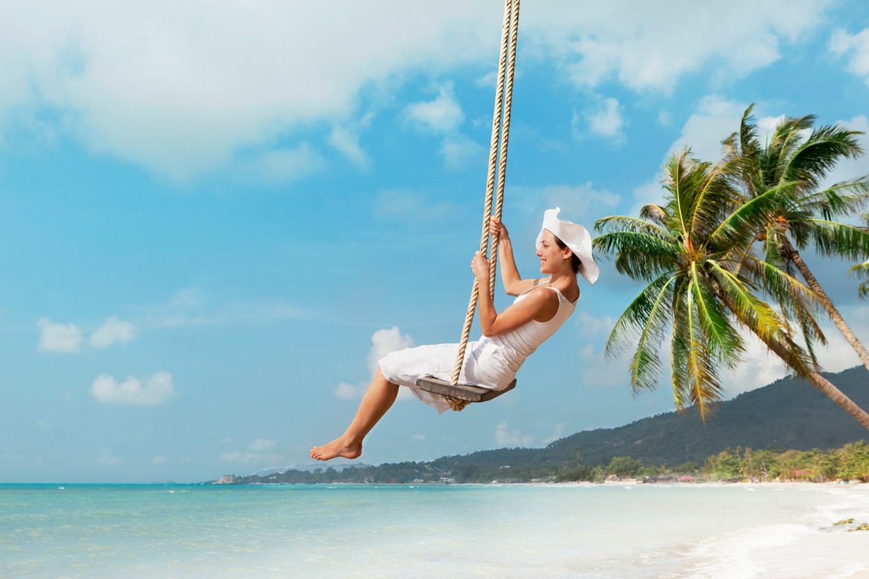 Woman swinging at beach