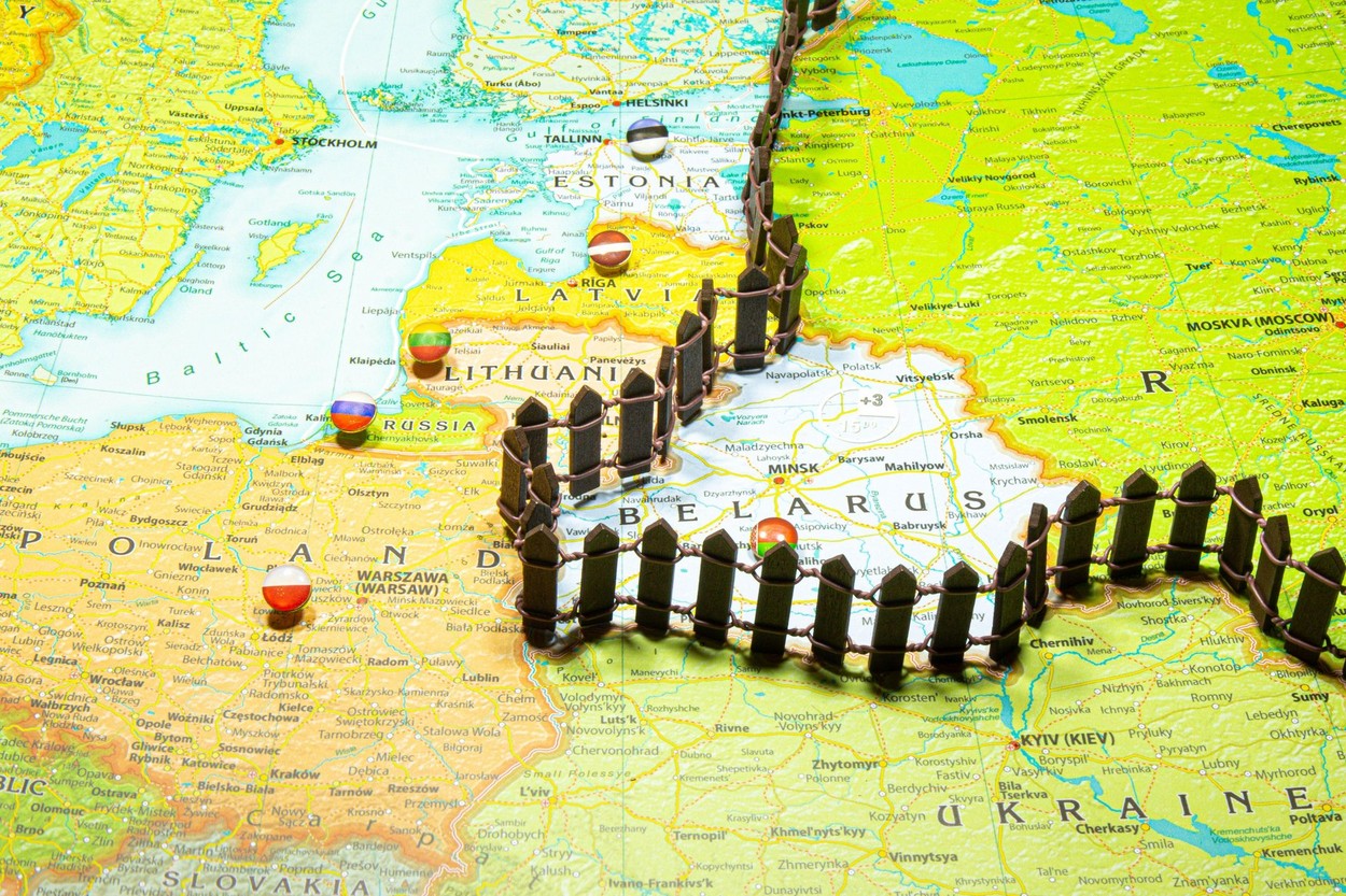 Concept of common border Russia and Belarus. Fence separating from European countries NATO Latvia Lithuania and Estonia. Close up picture on a colorfu