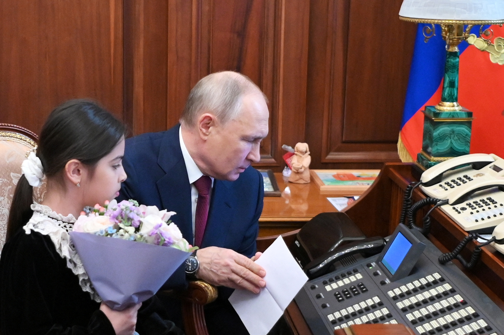 Russian President Vladimir Putin meets with Raisat Akipova, an 8-year-old girl from Dagestan, at the Kremlin in Moscow