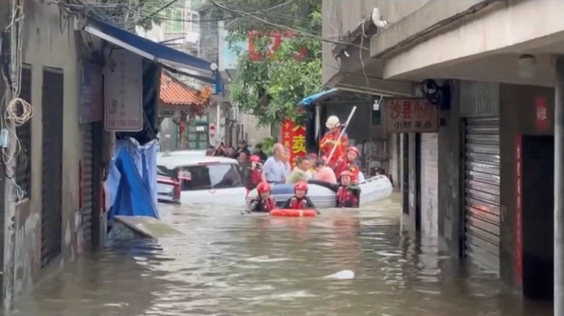 Rescue workers evacuate residents stranded by floodwaters, in Fuzhou