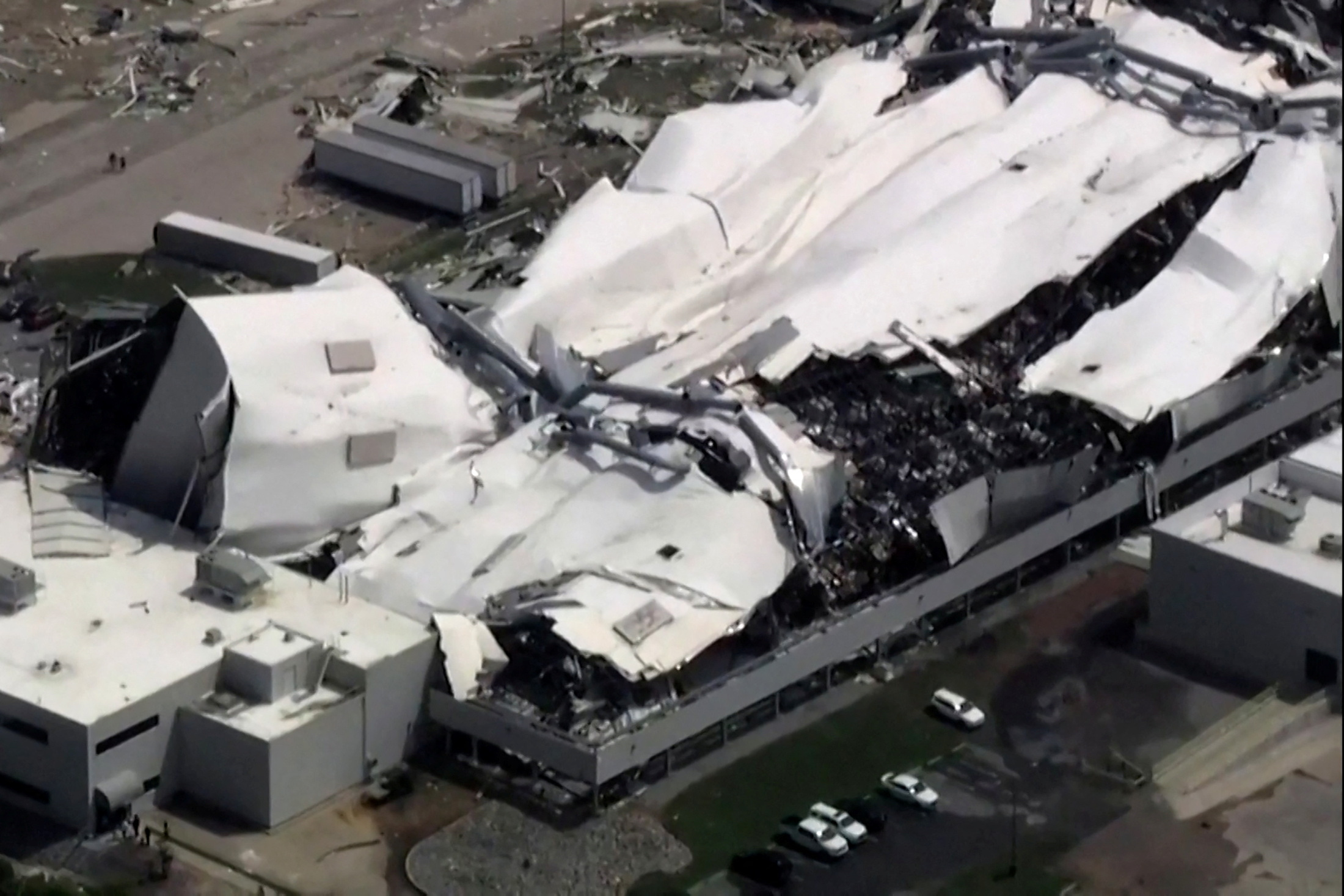 The roof of a Pfizer facility shows heavy damage after a tornado passed the area in Rocky Mount