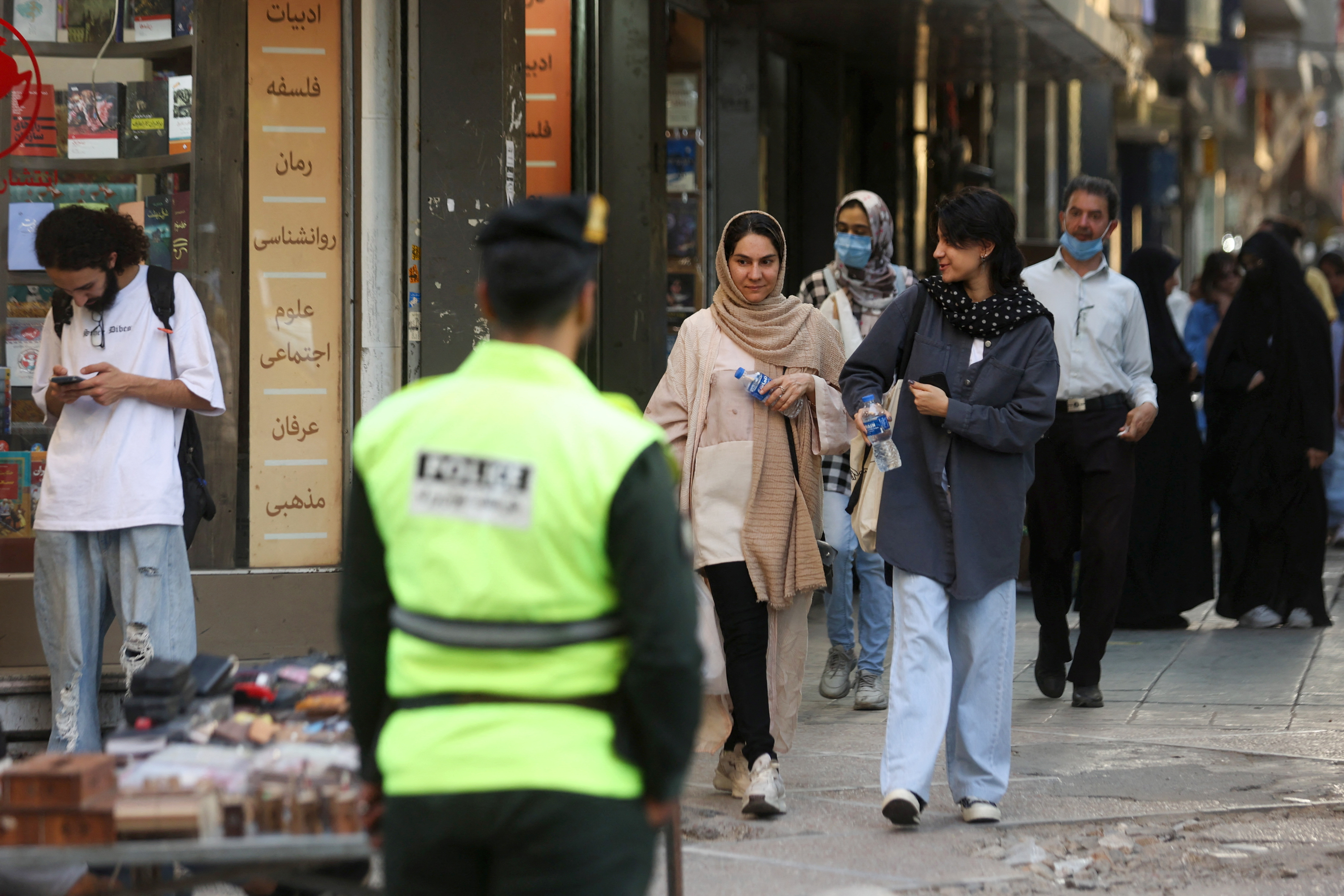 Iranian women walk on a street during the revival of morality police in Tehran