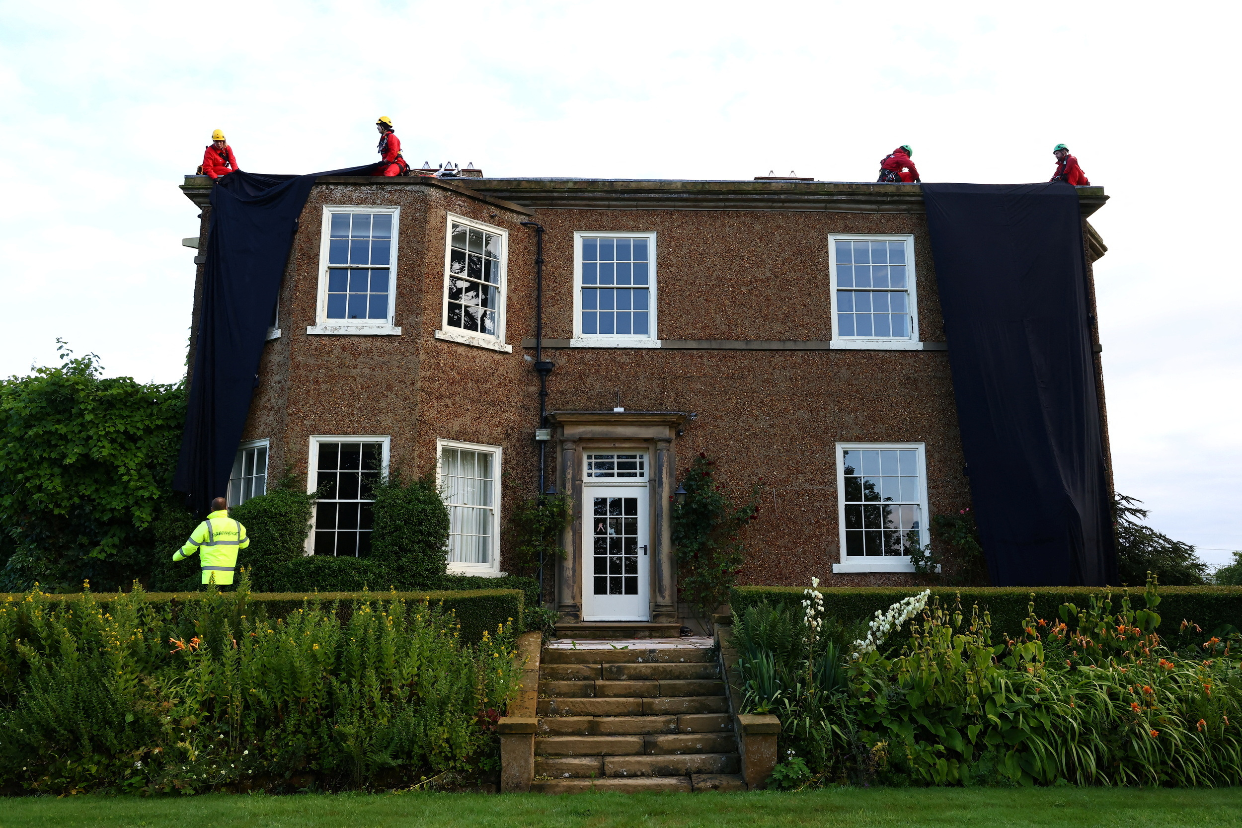 Greenpeace activists cover Rishi Sunak's mansion in oil-black fabric, in Yorkshire