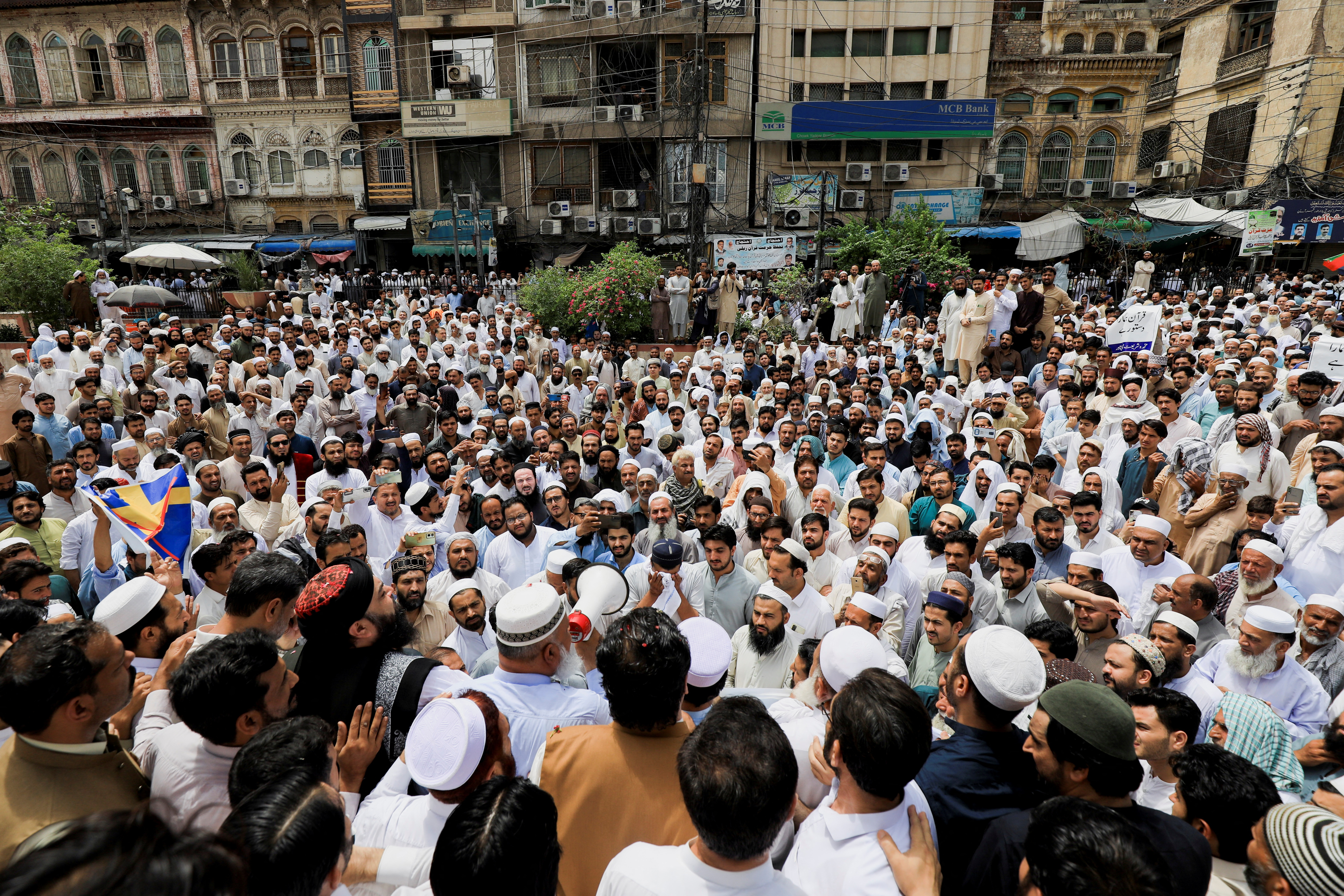 People protest following the desecration of Koran outside a mosque in Stockholm, in Karachi