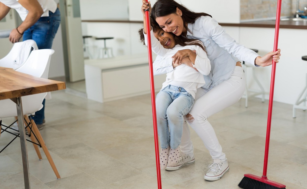 Happy mother with her child cleaning house