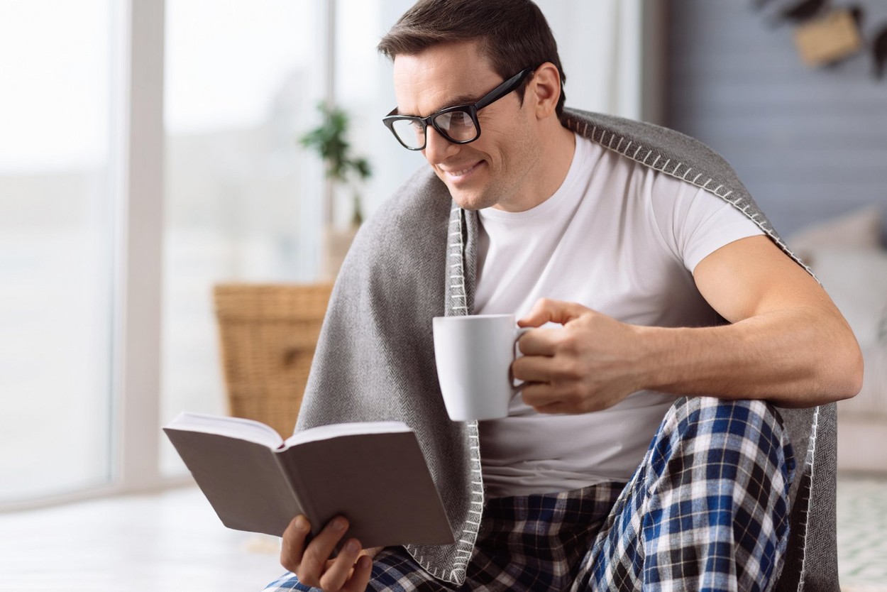 Intelligent handsome man reading a book