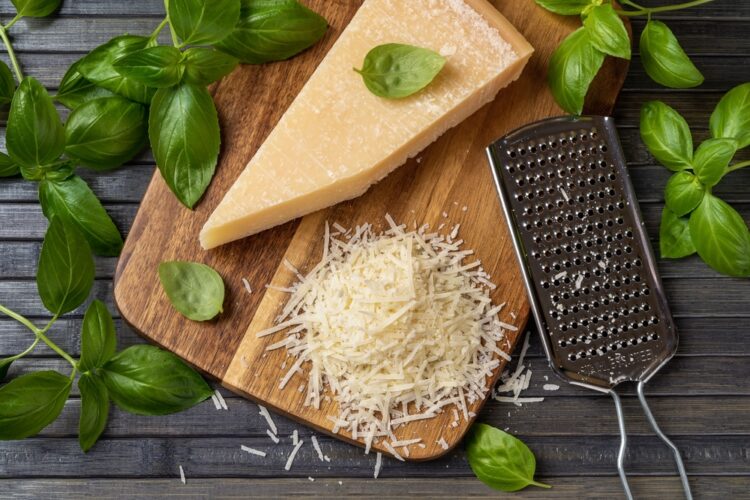 Parmesan,Cheese,With,Grater,On,A,Cutting,Board.,Whole,Wedge