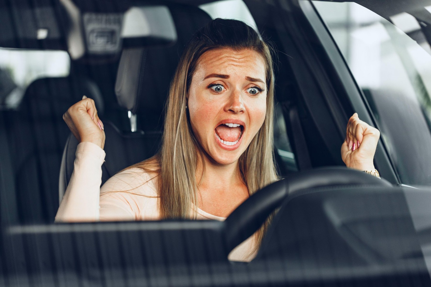 Mad woman driving a car stuck in a traffic jam