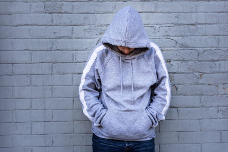 Lonely Man Leaning against an urban wall