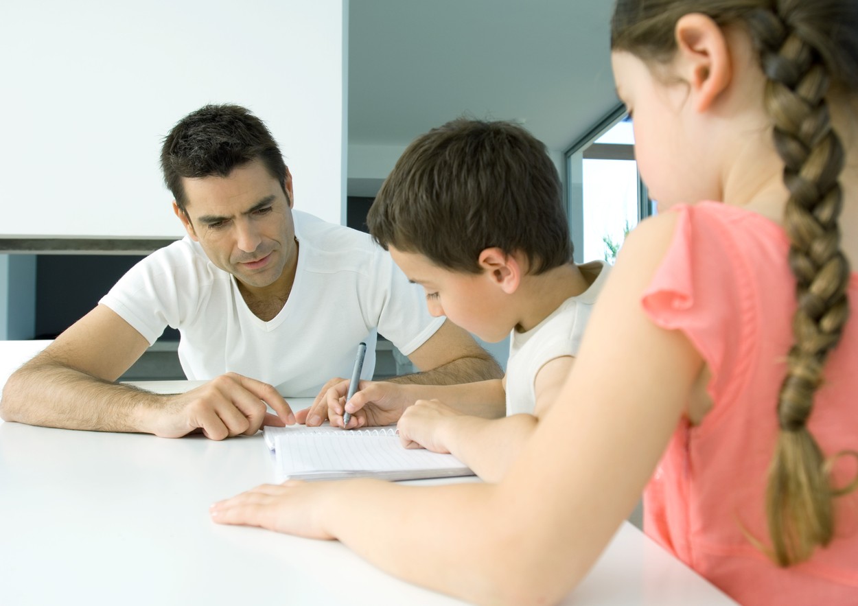 Father helping children with homework