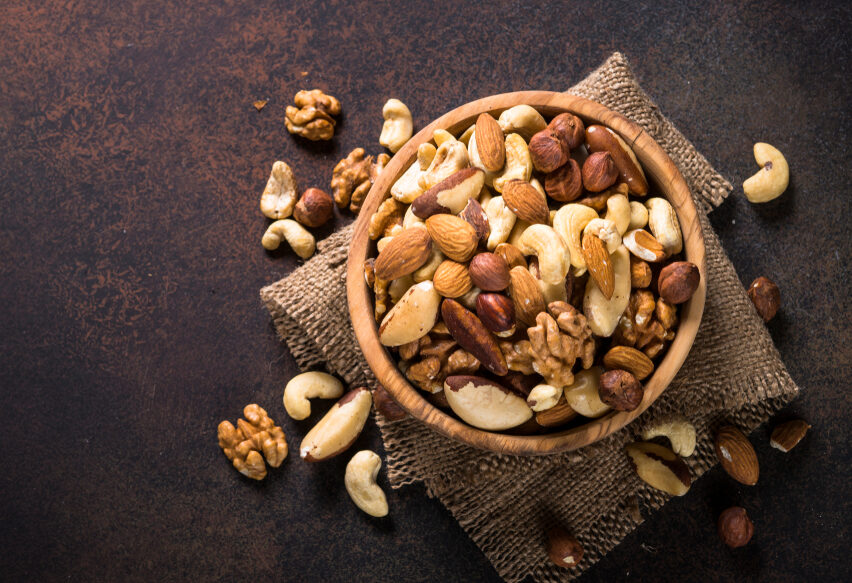 Assortment,Of,Nuts,In,Wooden,Bowl,On,Dark,Stone,Table.