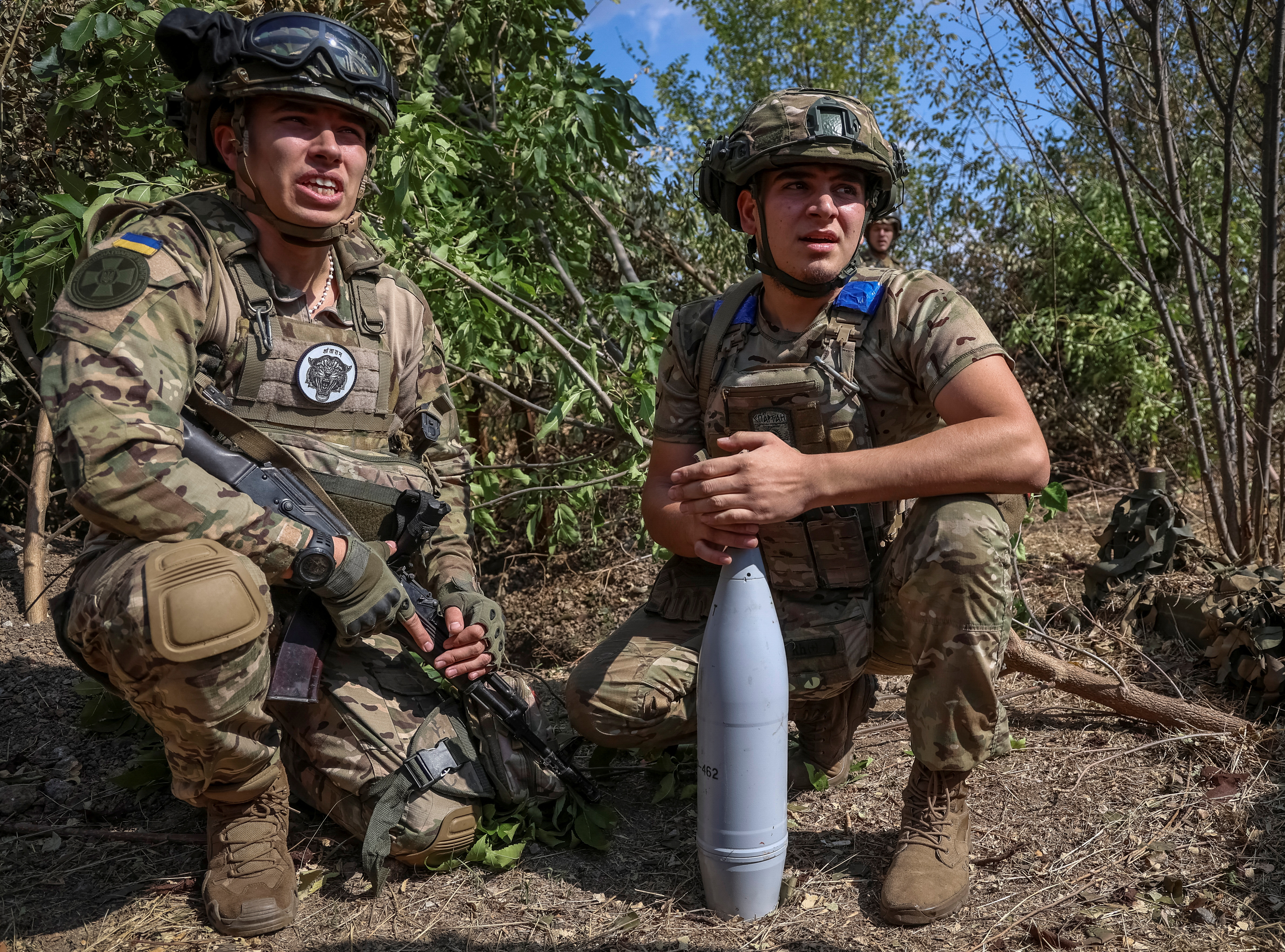 Ukrainian servicemen of the Spartan Brigade of the National Guard of Ukraine prepare a shell for a D-30 howitzer at a position at a front line in Zaporizhzhia region