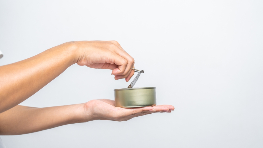 Hand,Holds,Canned,Food,Isolated,On,White,,Woman,Hands.