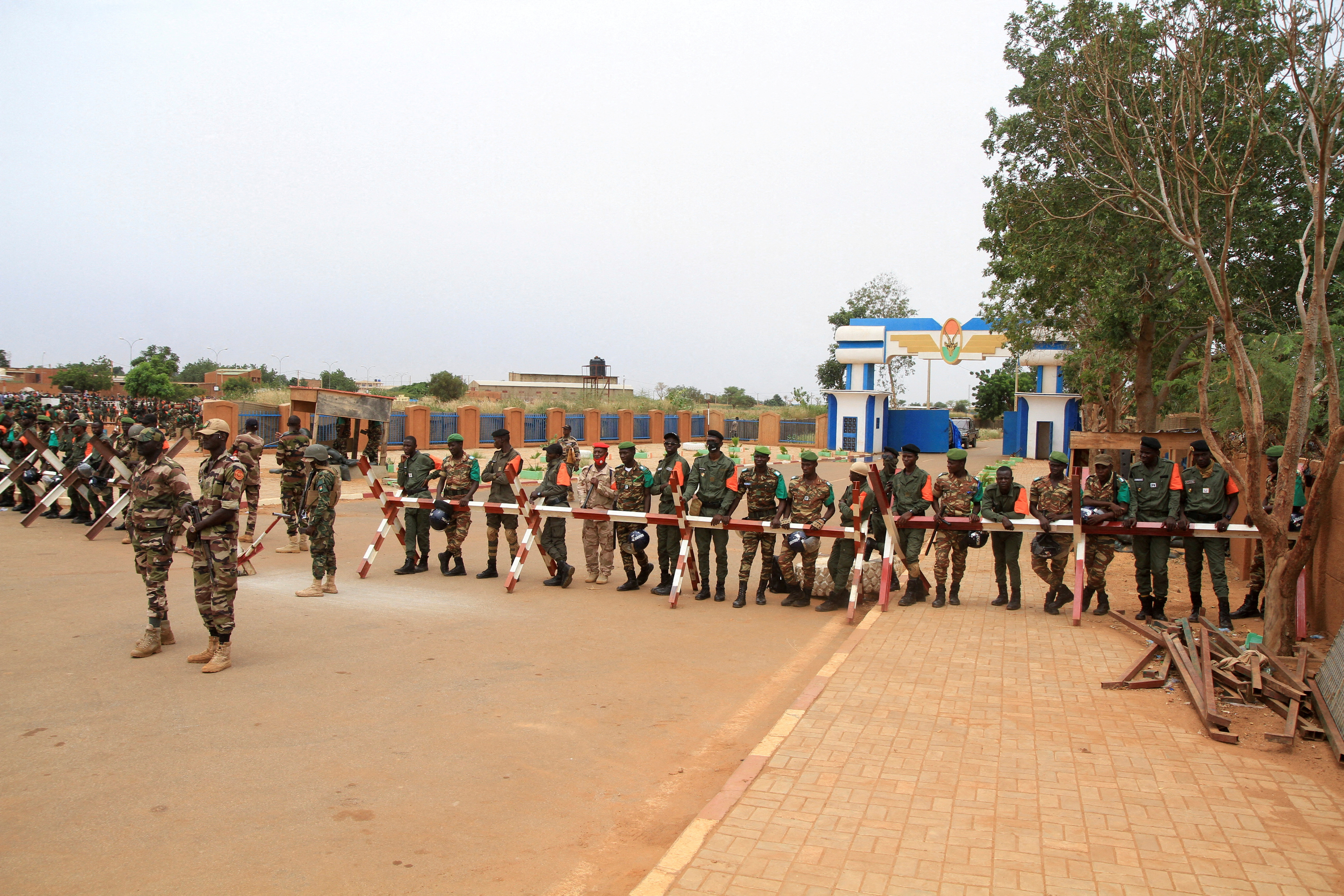 Nigeriens perform their Friday prayers in front of the French army base in Niamey