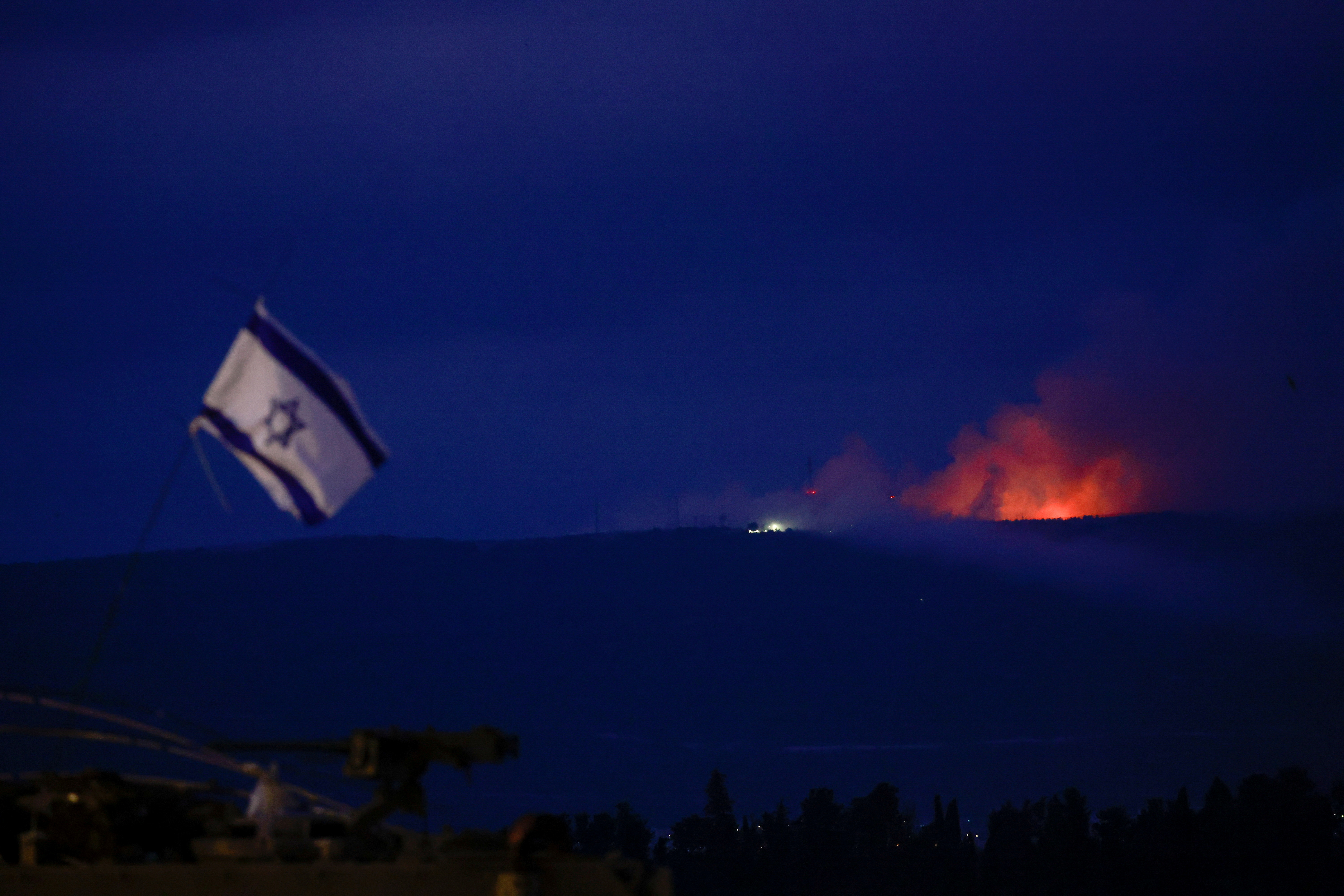 Flame and smoke rise over Lebanon as seen from Israel's border with Lebanon, in northern Israel