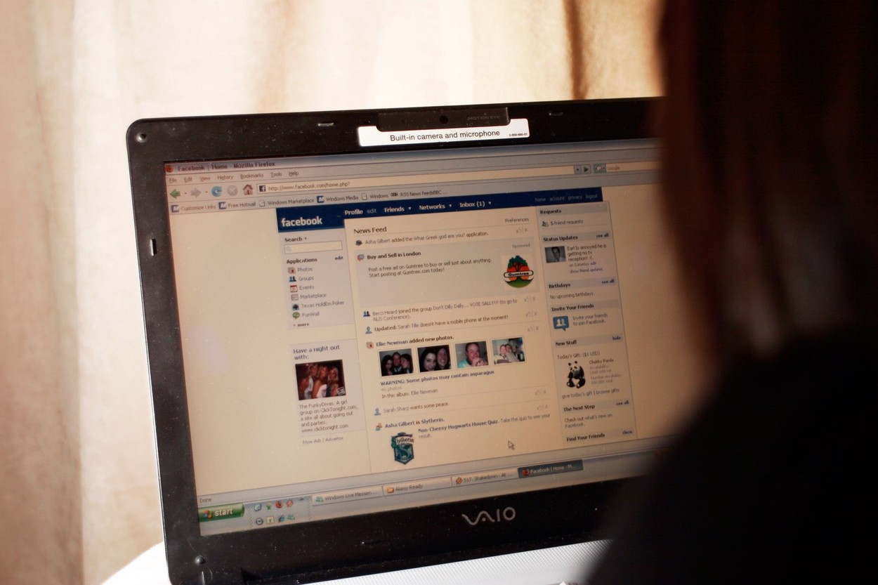 Young female teenager woman mid early 20s using social networking site sites like Facebook BEBO MySpace to connect network