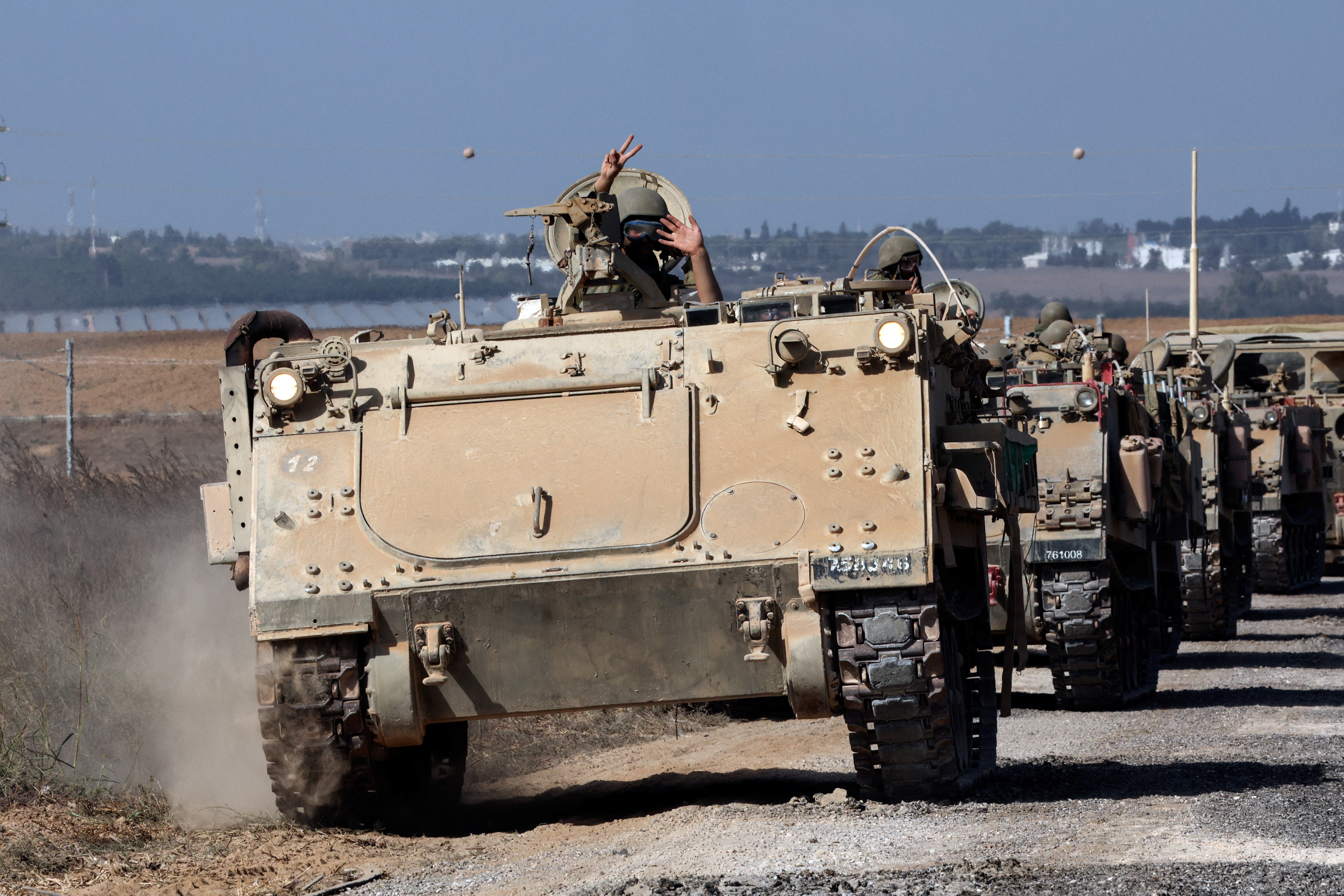 Israeli military vehicles take up position near Israel's border with the Gaza Strip, in southern Israel