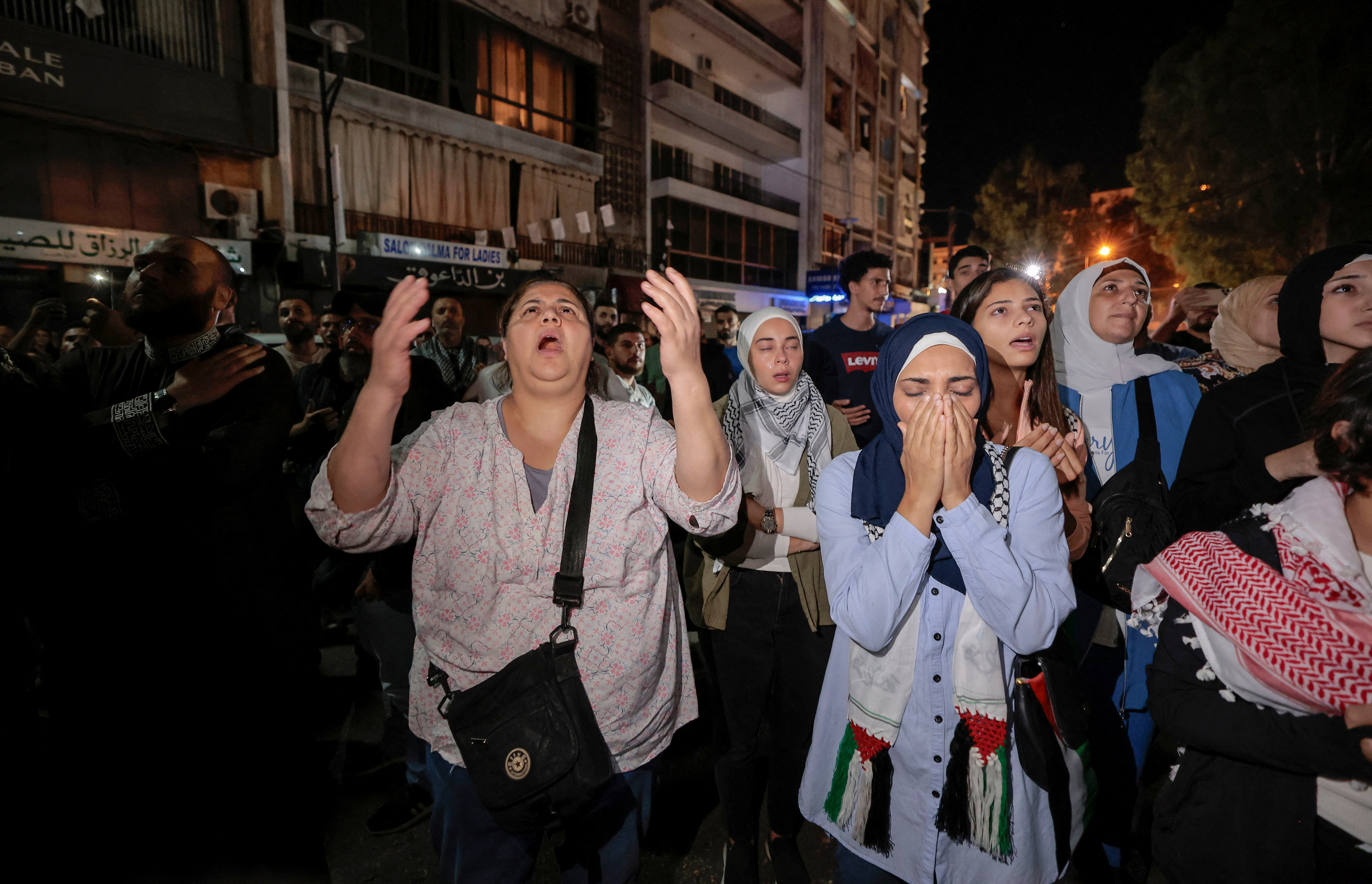 People pray as they protest after hundreds of Palestinians were killed in a blast at Al-Ahli hospital in Gaza that Israeli and Palestinian officials blamed on each other, in Beirut,