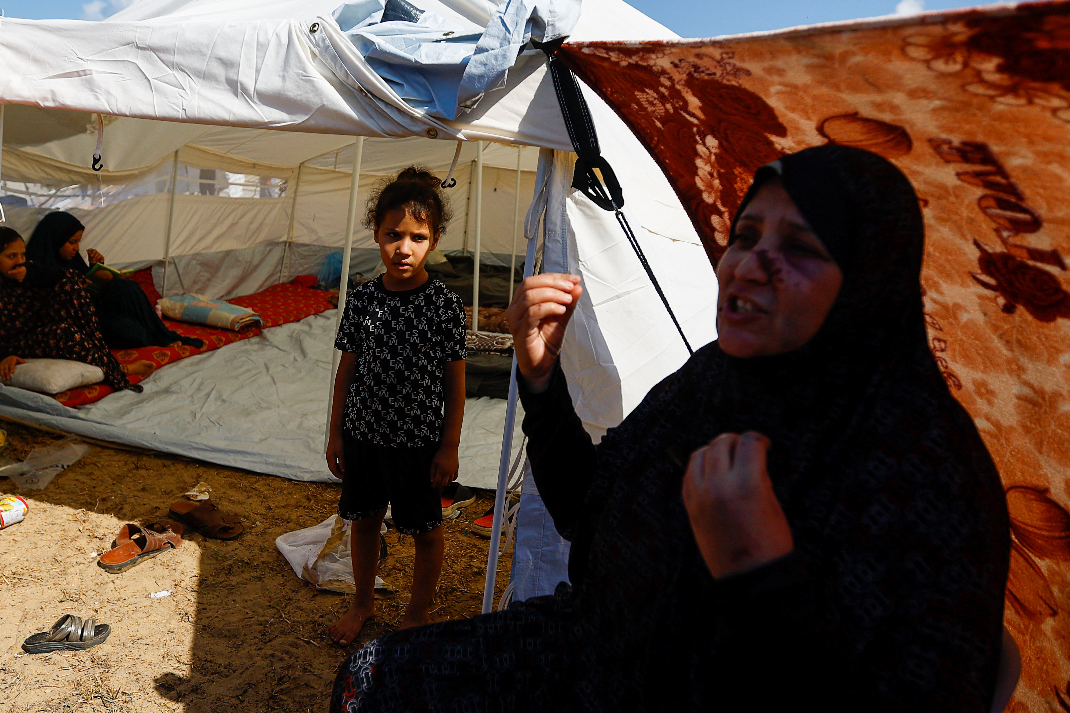 Palestinians, who fled their house amid Israeli strikes, shelter at a United Nations-run centre in Khan Younis