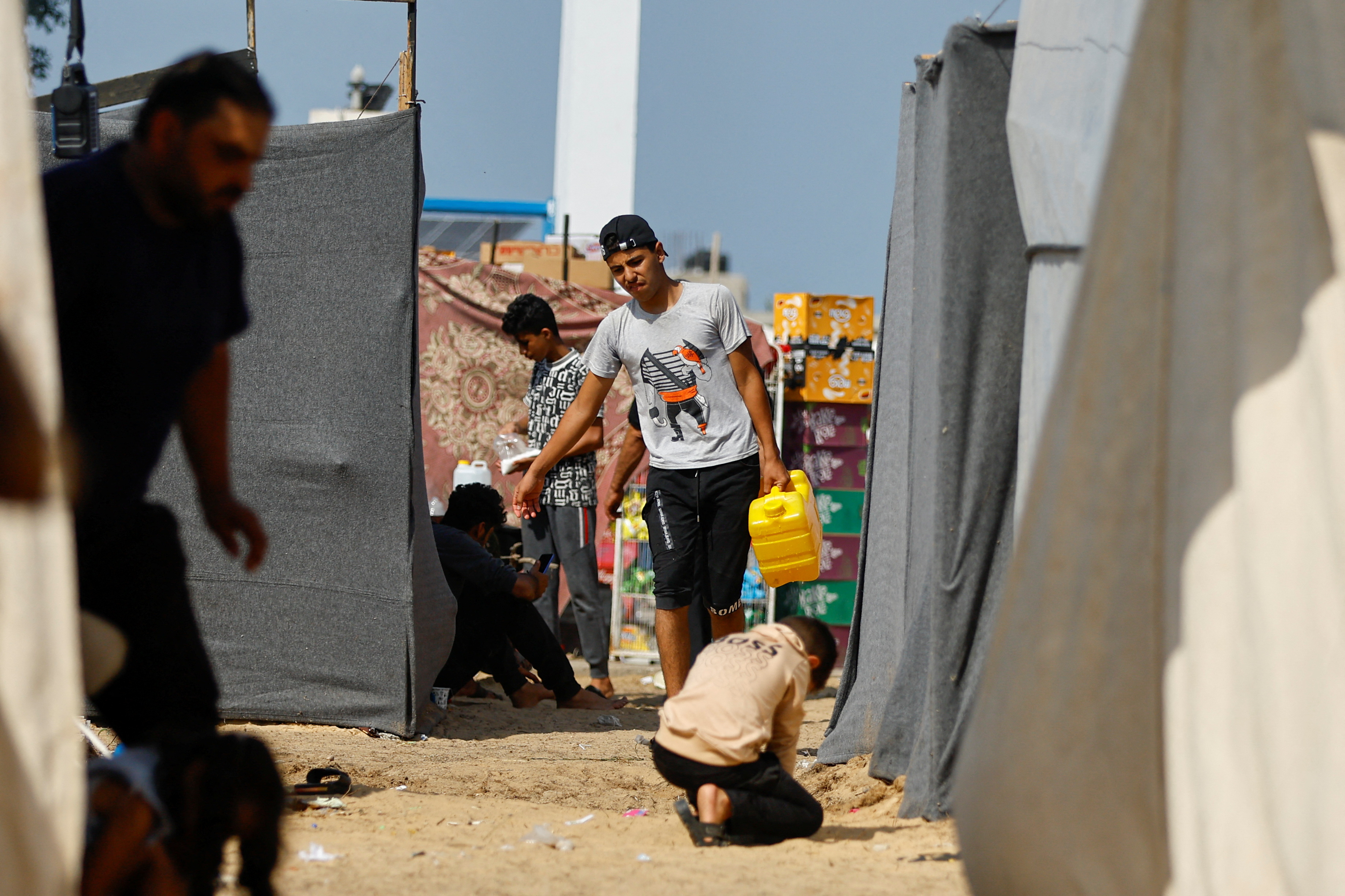 Palestinians take shelter in a tent camp at a United Nations-run centre in Khan Younis