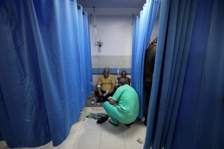 People are assisted at Shifa Hospital after hundreds of Palestinians were killed in a blast at Al-Ahli hospital in Gaza that Israeli and Palestinian officials blamed on each other