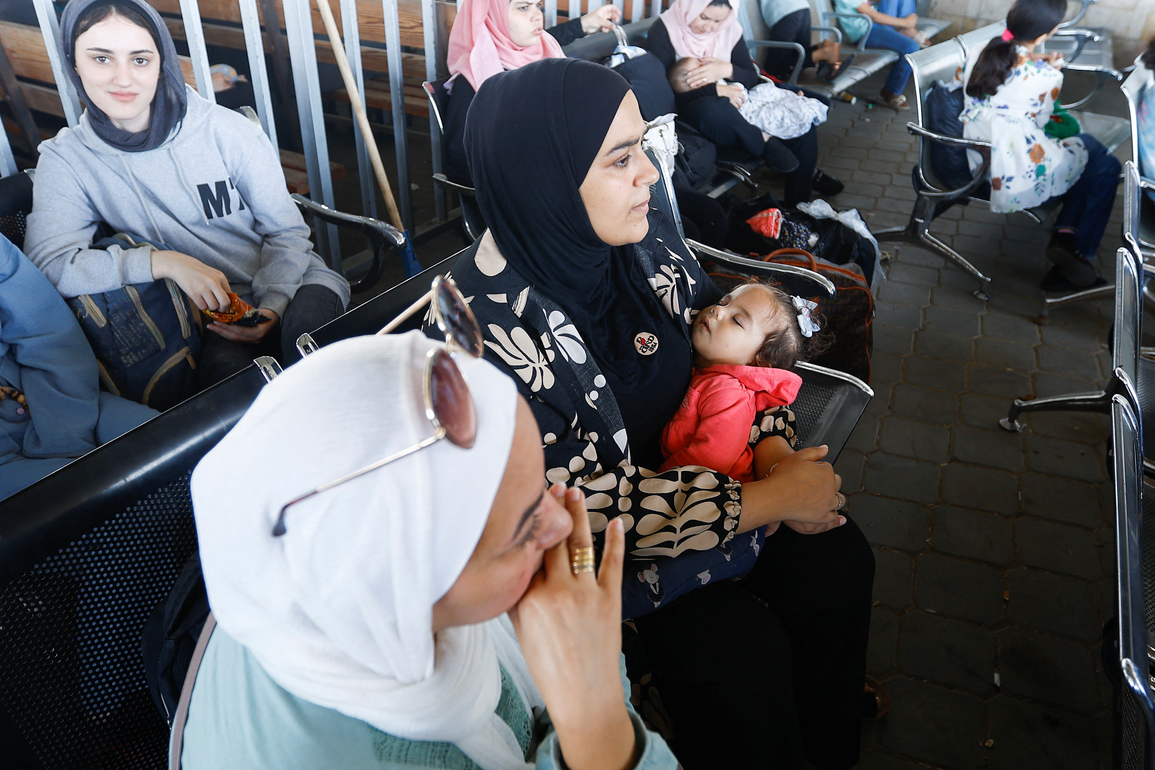 Palestinians with dual citizenship wait at the Rafah border crossing with Egypt, in the hope of getting permission to leave Gaza