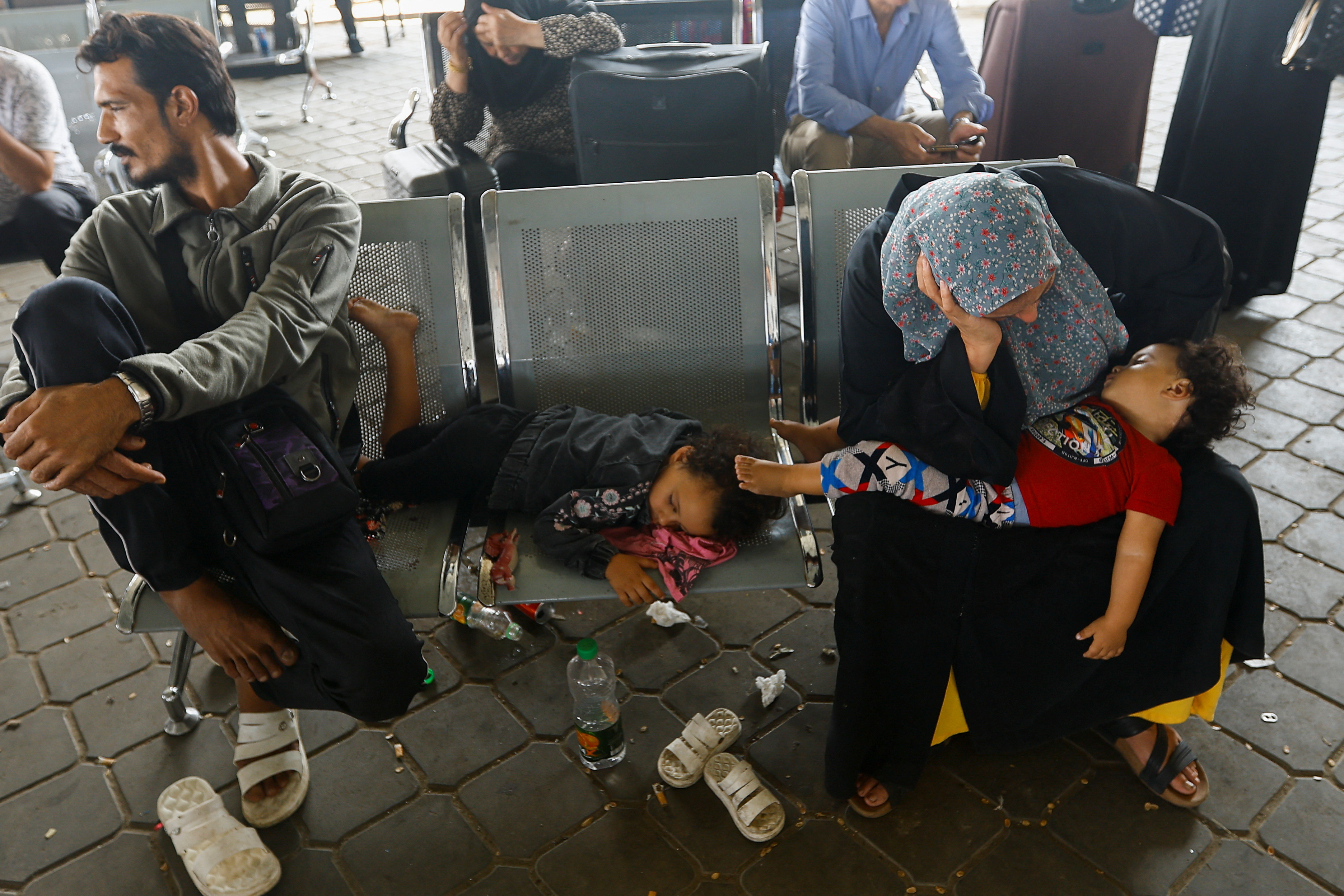 Palestinians wait for permission to leave Gaza, at the Rafah border crossing with Egypt