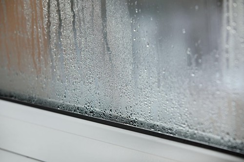 a plastic window with condensation of water on the glass. Double glazed PVC window. Concept: defective plastic window with condensation, temperature difference, cooling, humidity in the room