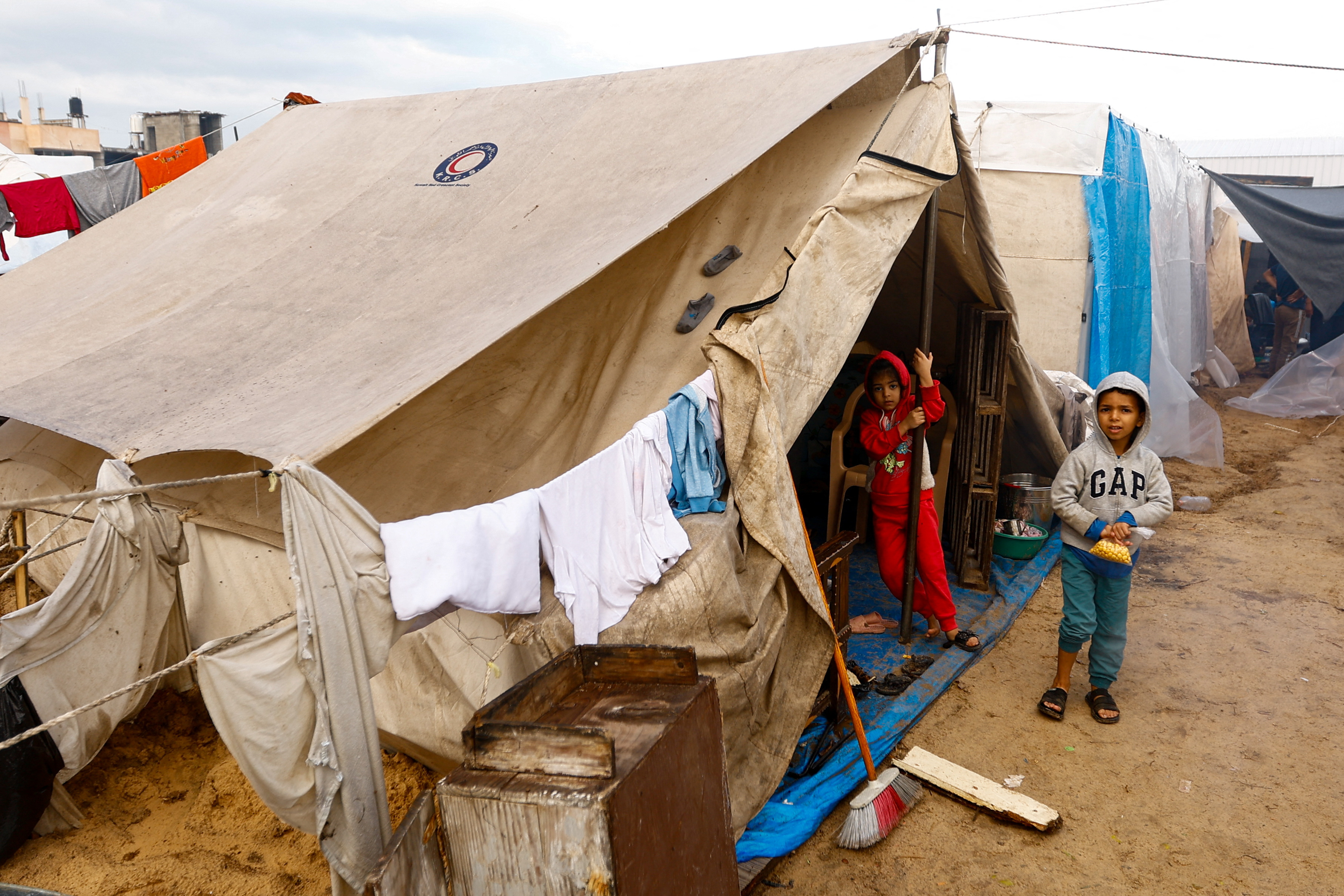 Displaced Palestinians shelter in a tent camp, in Khan Younis