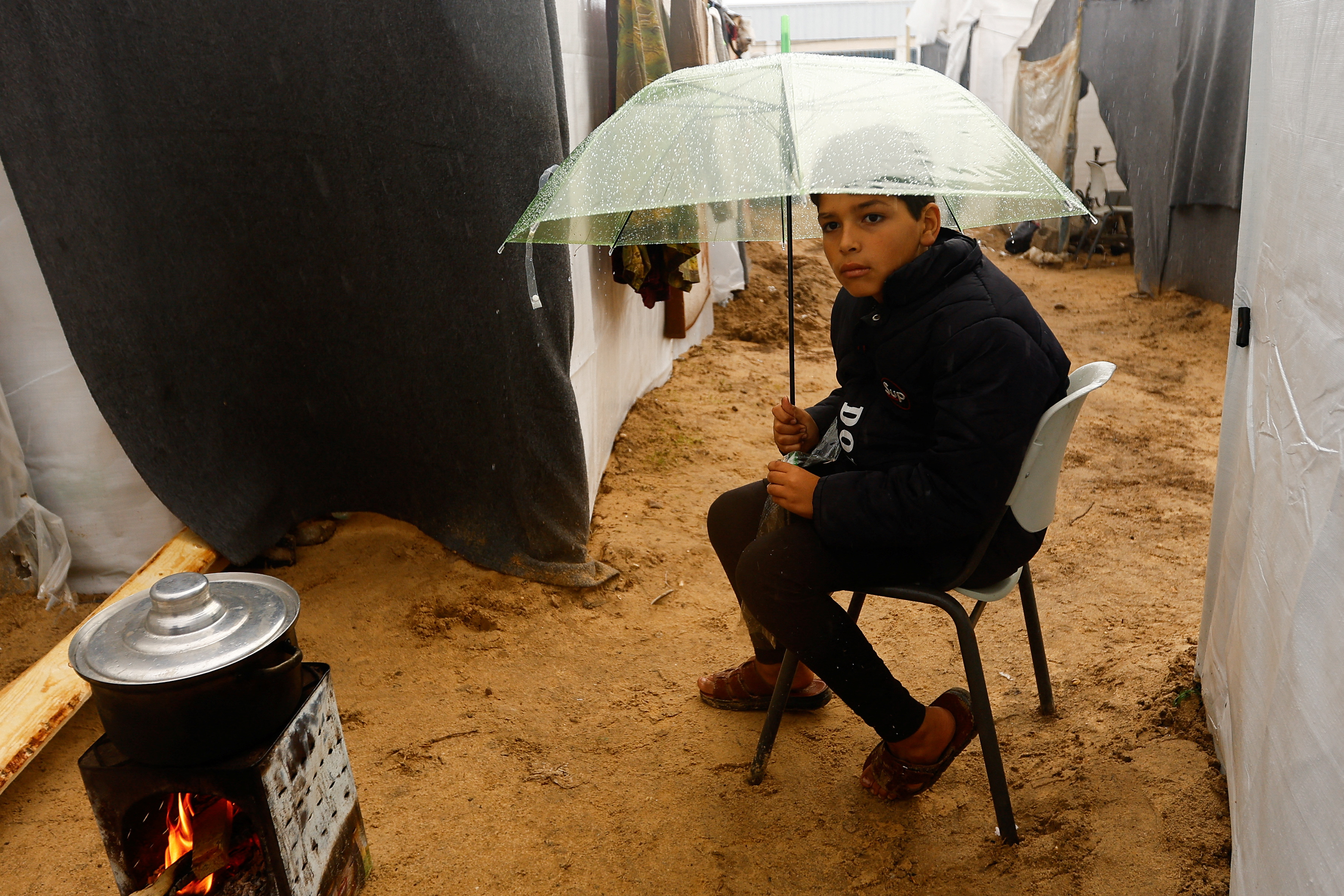 Displaced Palestinians shelter in a tent camp, in Khan Younis