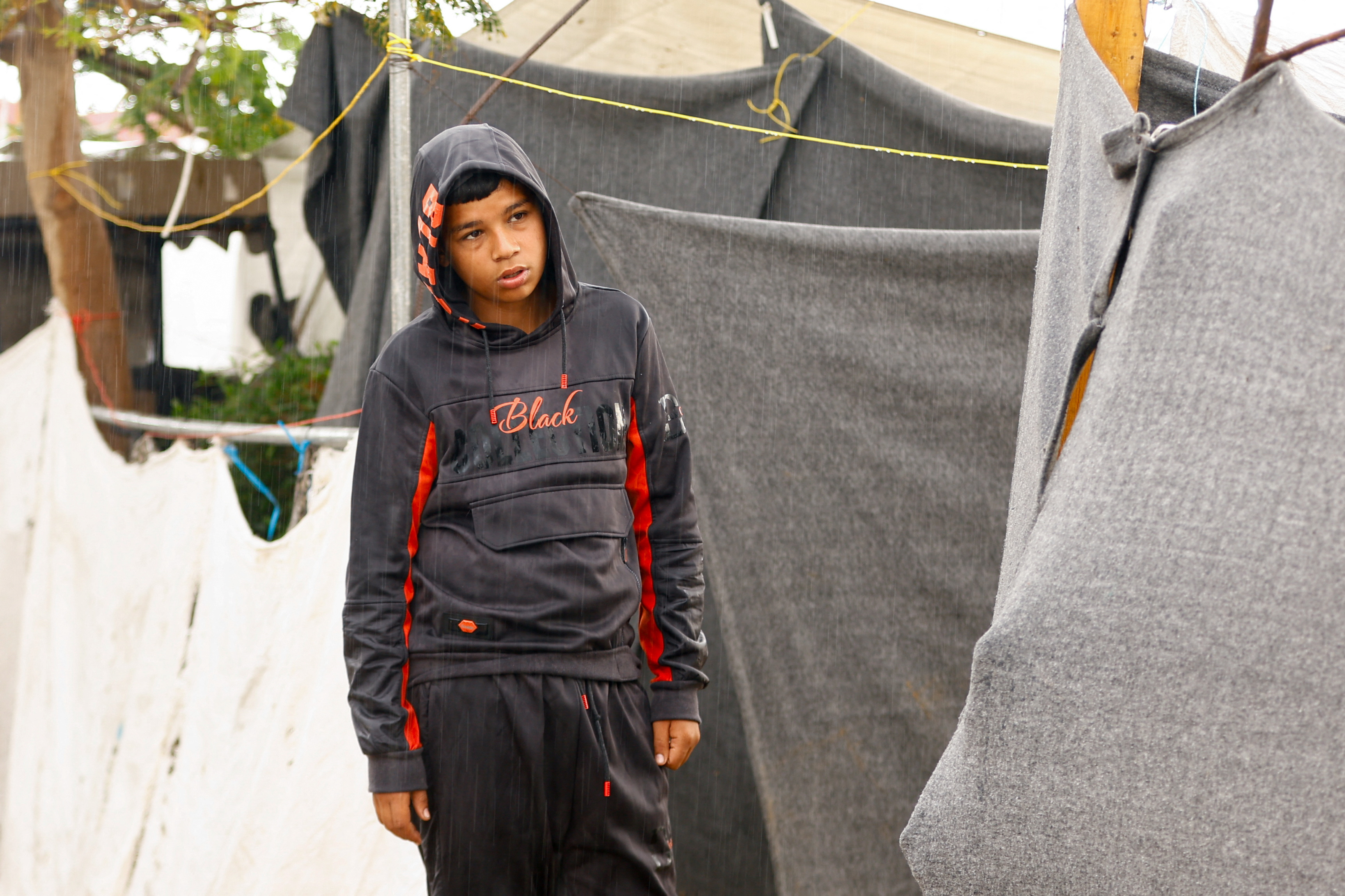 Displaced Palestinians shelter in a tent camp, in Khan Younis