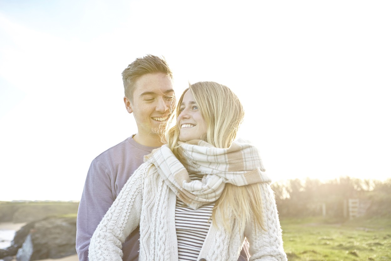 Happy young couple on date at beach