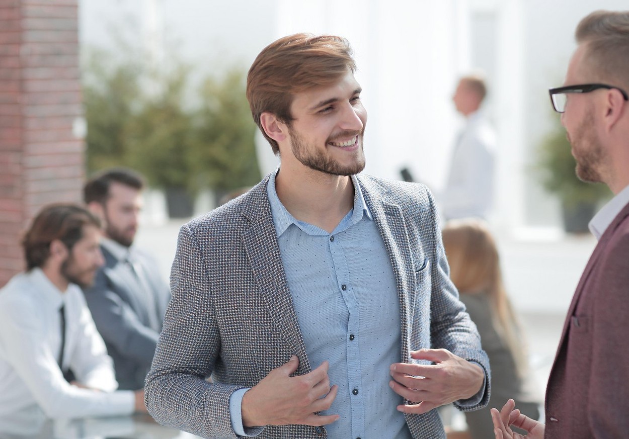 two business men talking standing in the office
