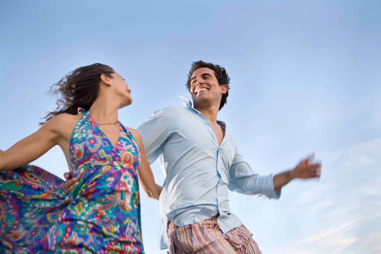 Loving couple running outside