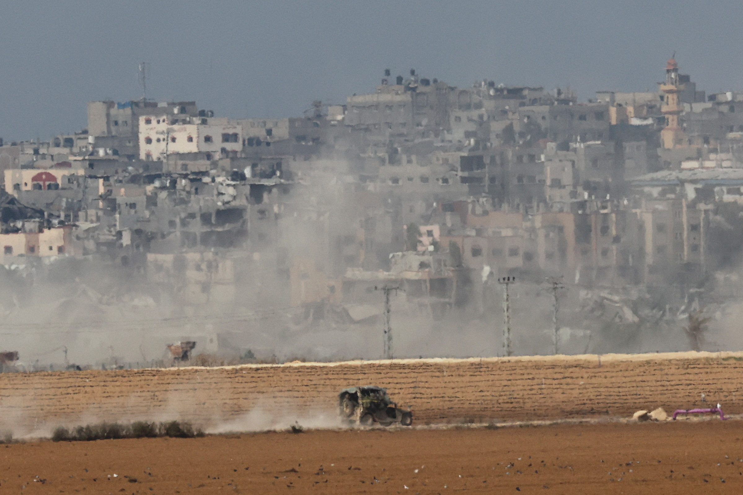 Israeli military vehicle operates, near the Israel-Gaza border, as seen from southern Israel