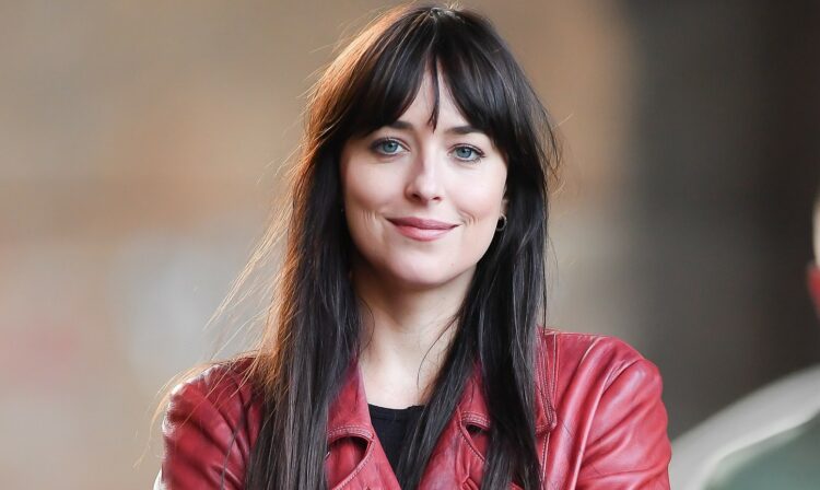 Dakota Johnson drives a yellow cab on set of "Madame Web" in New York City