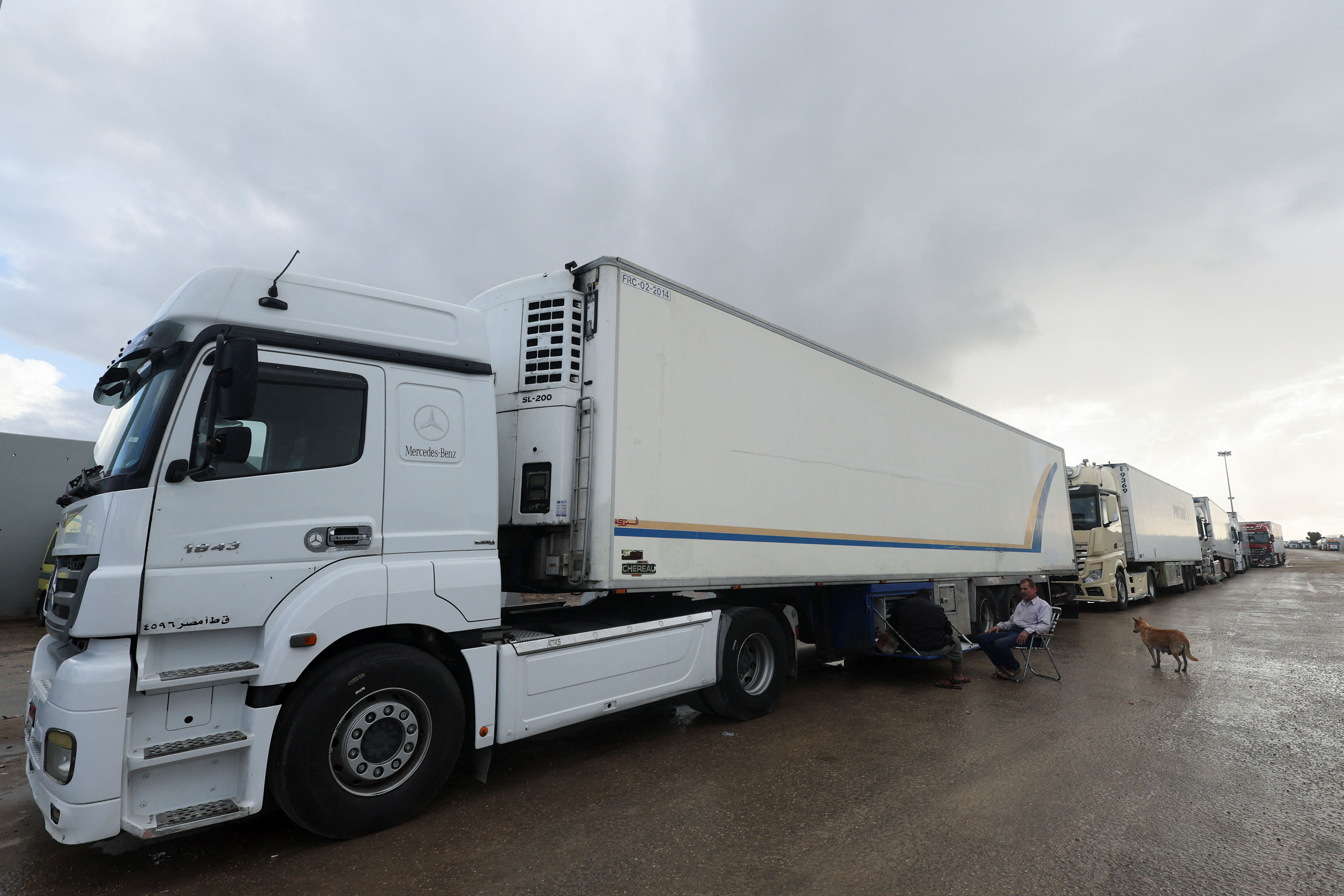 Trucks with humanitarian aid wait on the Egyptian side of the Rafah border crossing