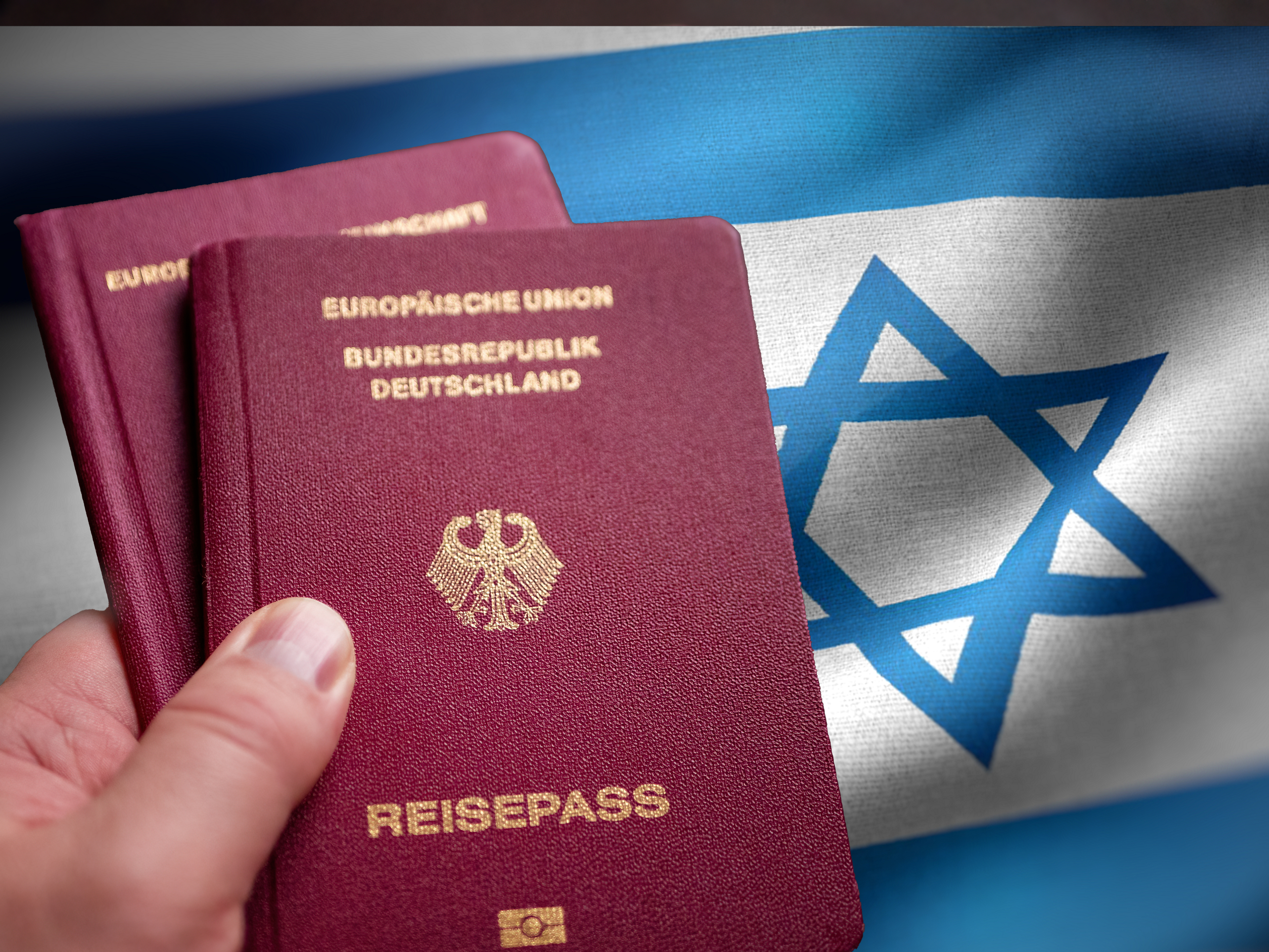 Two,German,Passport,In,Male,Hand,On,Check,In.,Concept