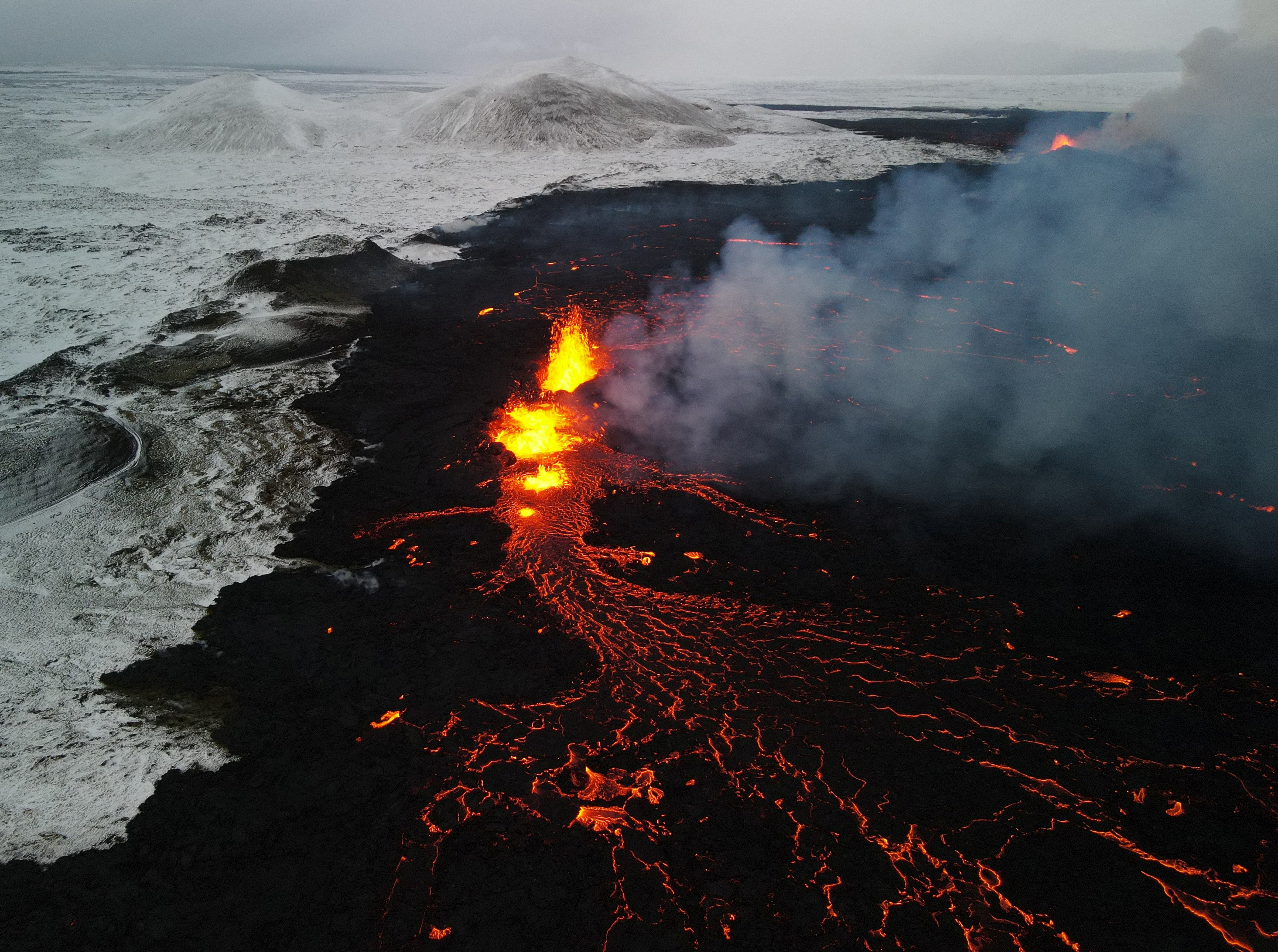An aerial view of lava spewing from the site of the volcanic eruption north of Grindavik