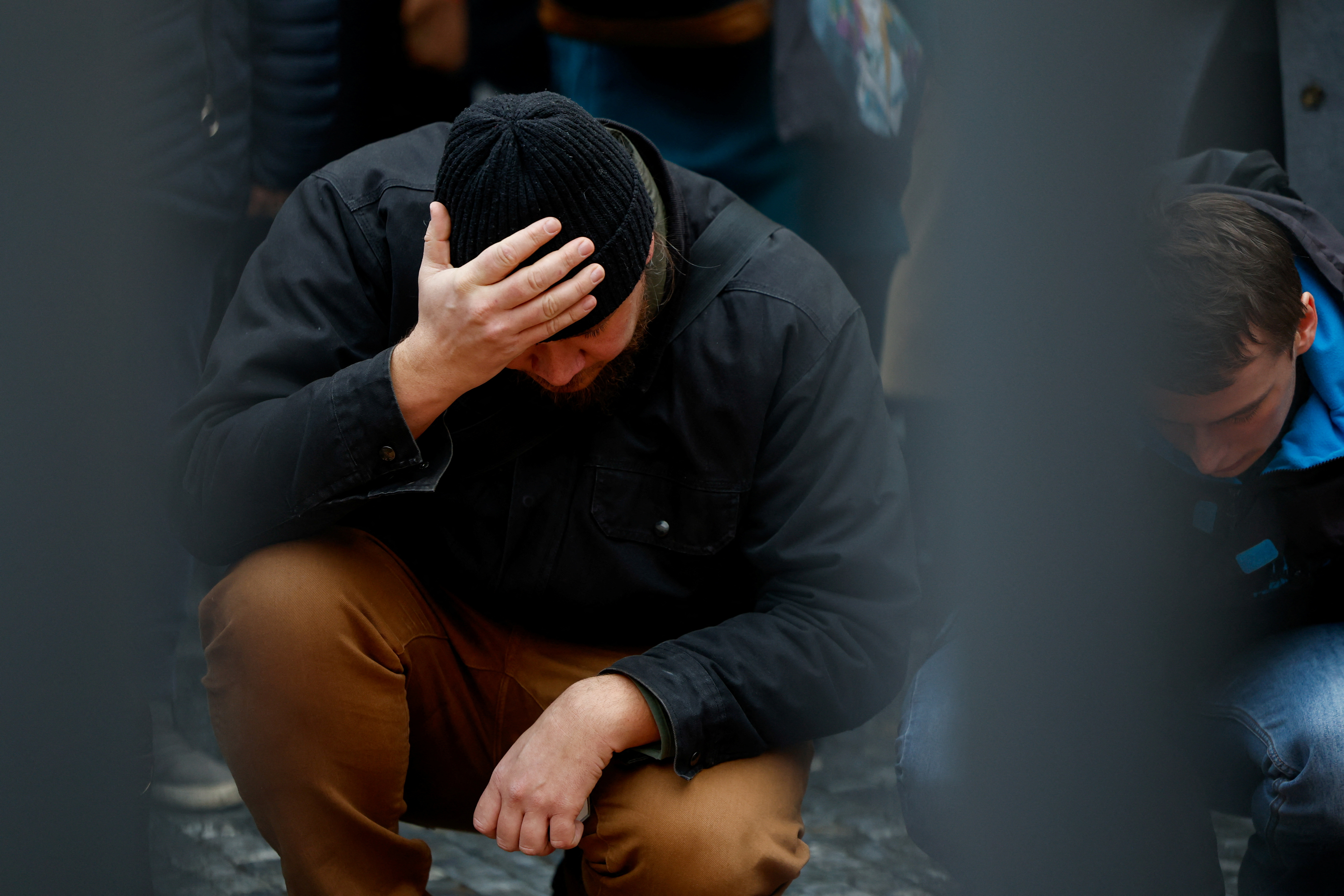 People hold a vigil to honour victims of Prague shooting