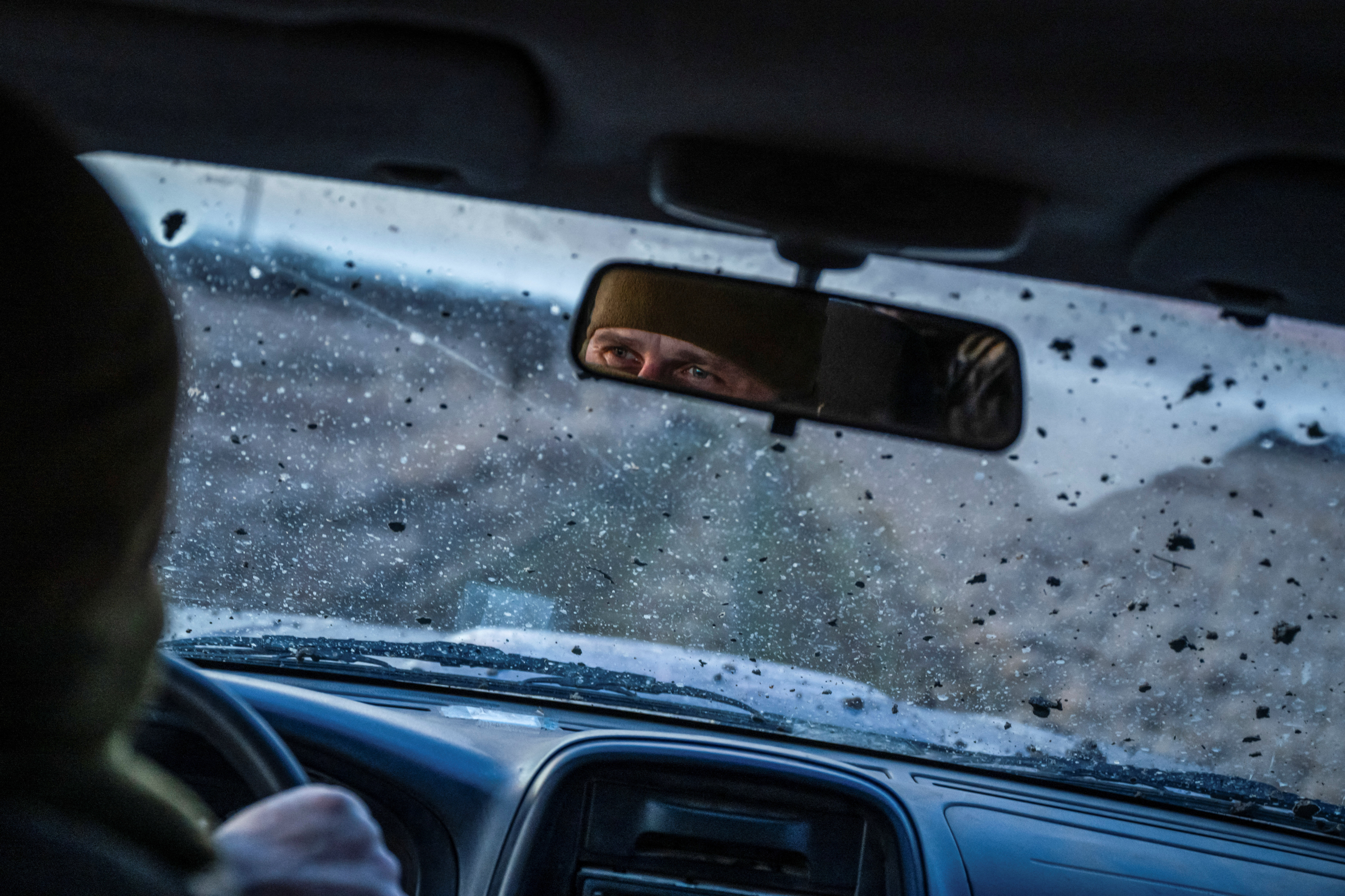 Ukrainian Army sniper drives a car on a road near the frontline town of Bakhmut