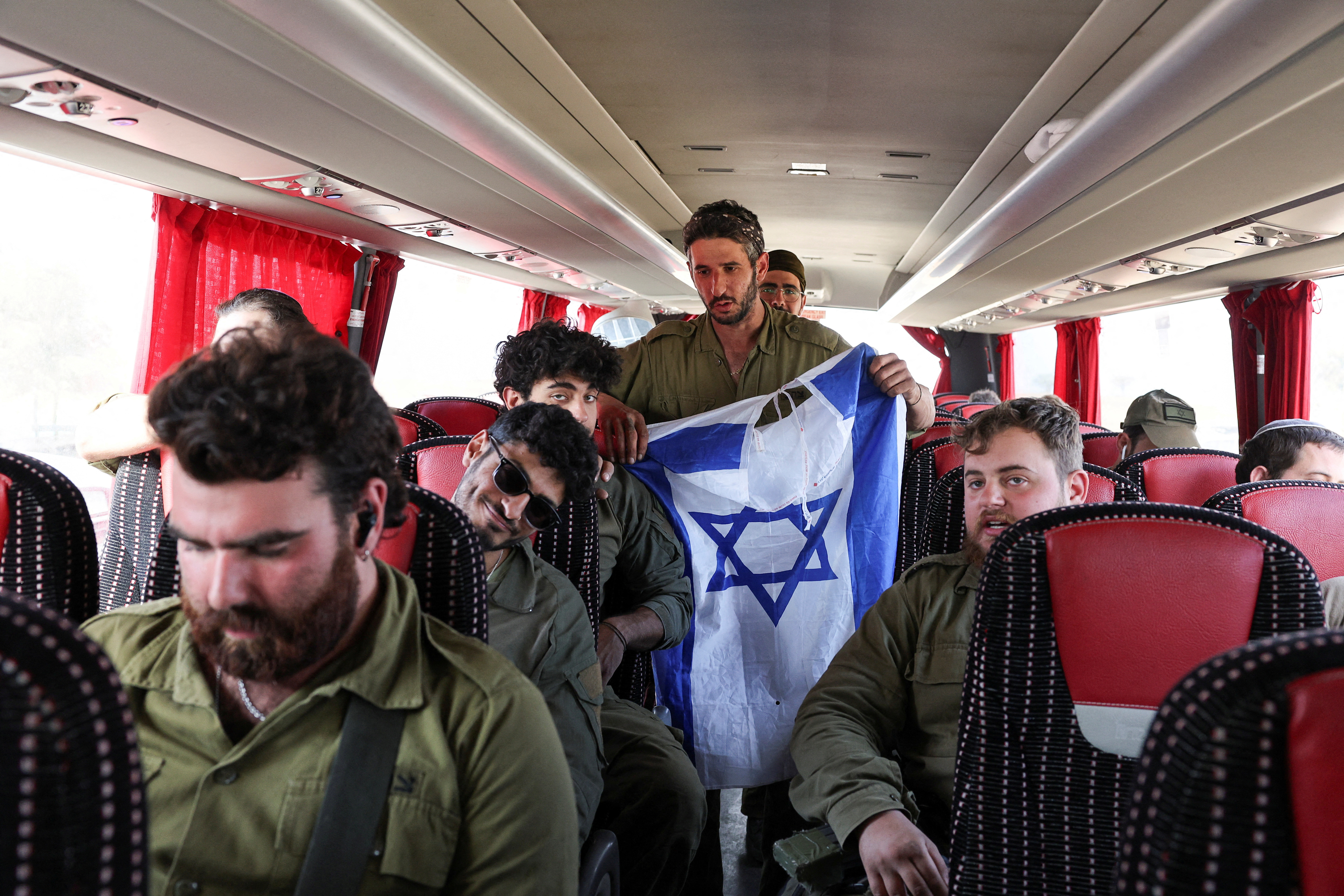 Israeli soldiers return from the ground operation in Gaza, near the Israel-Gaza border, in Southern Israel