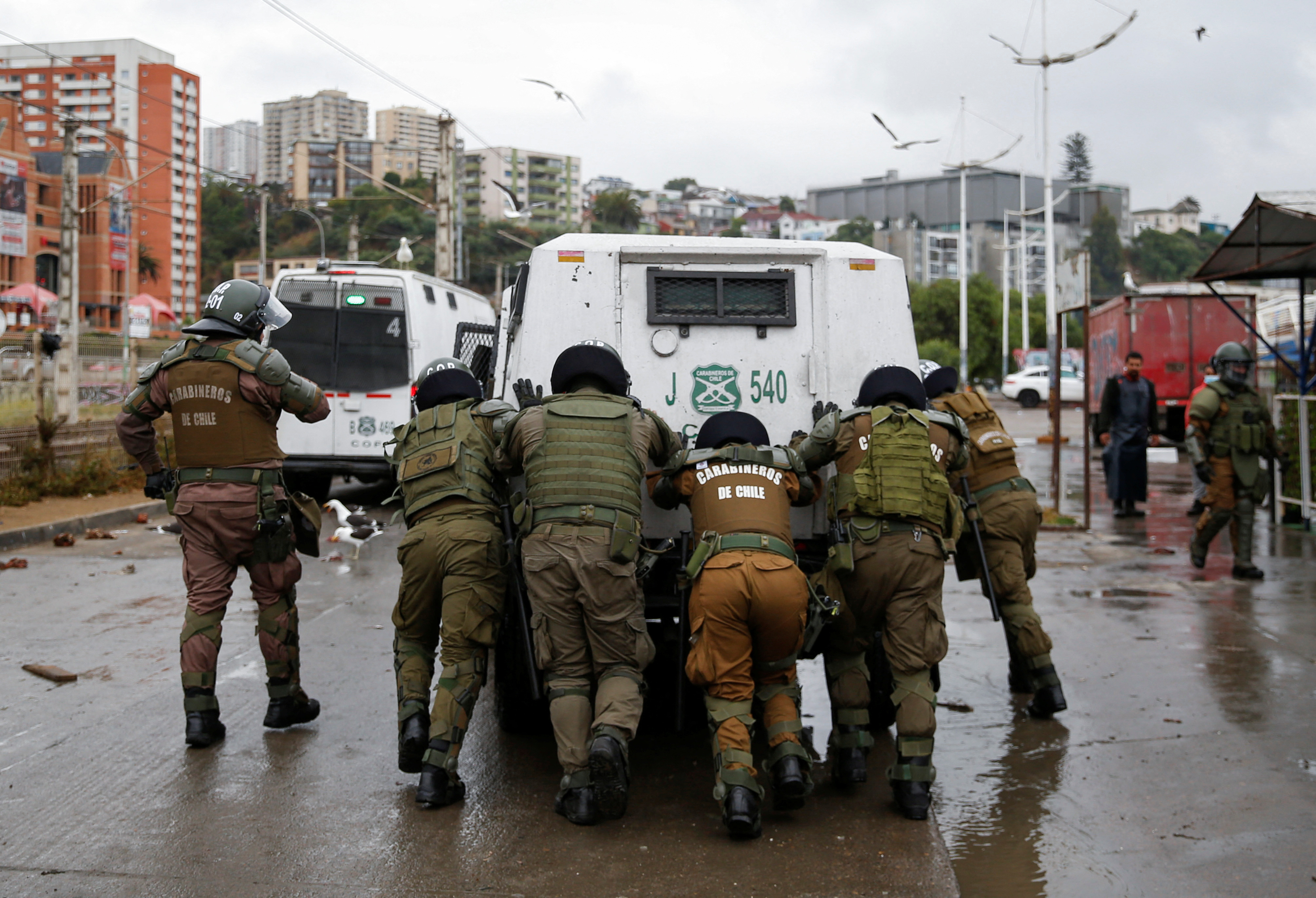 Fishermen clash with riot police during a protest against the government, in Valparaiso