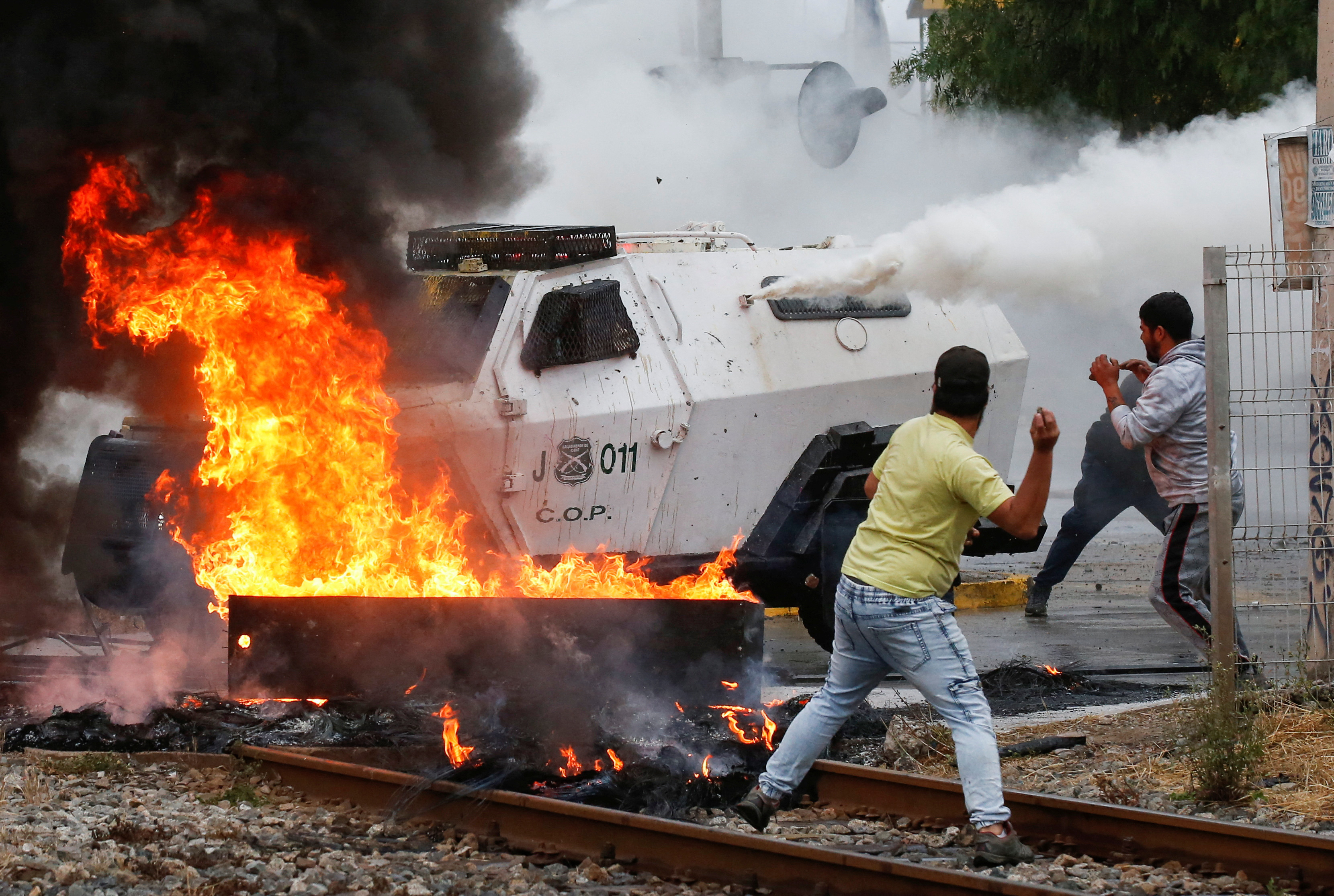 Fishermen clash with riot police during a protest against the government, in Valparaiso
