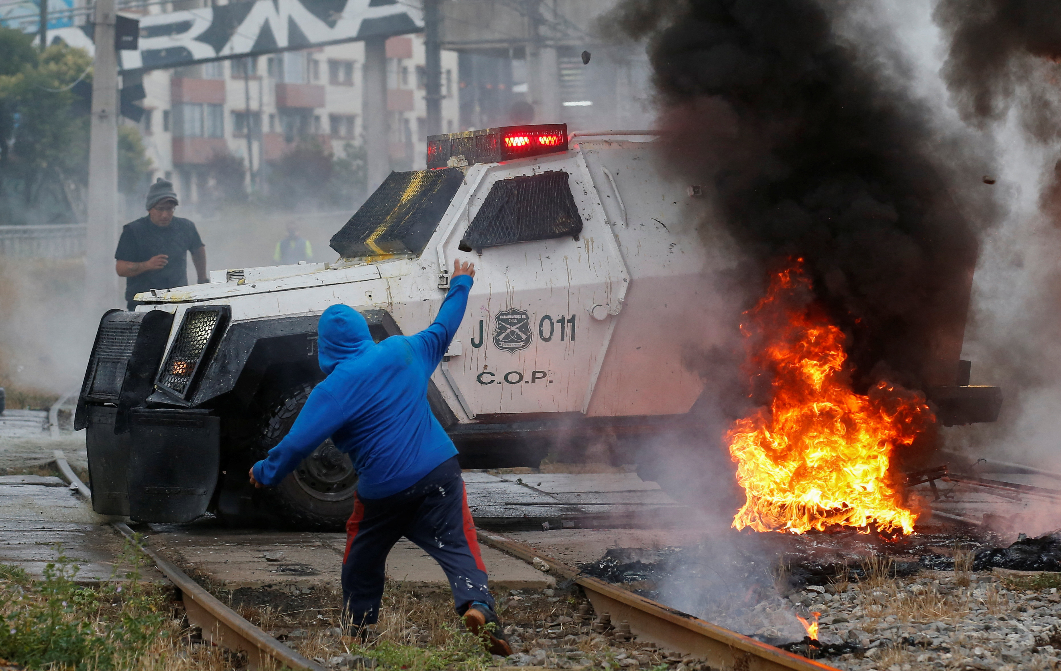 Fishermen clash with riot police during a protest against the government, in Valparaiso