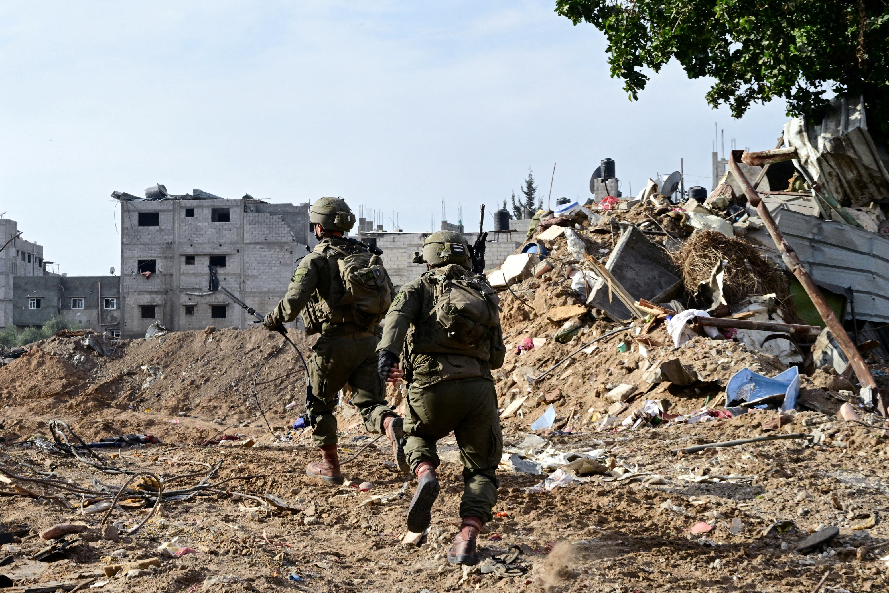 Israeli soldiers operate at the Shajaiya district of Gaza city amid the ongoing conflict between Israel and the Palestinian Islamist group Hamas, in the Gaza Strip
