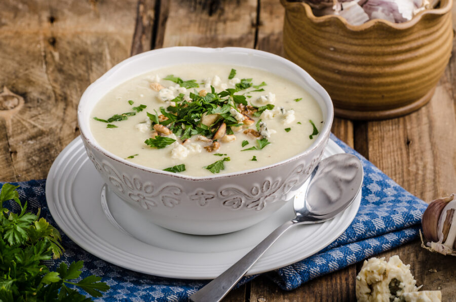 Cauliflower,Soup,With,Blue,Cheese,,Roasted,Nuts,And,Herbs,On